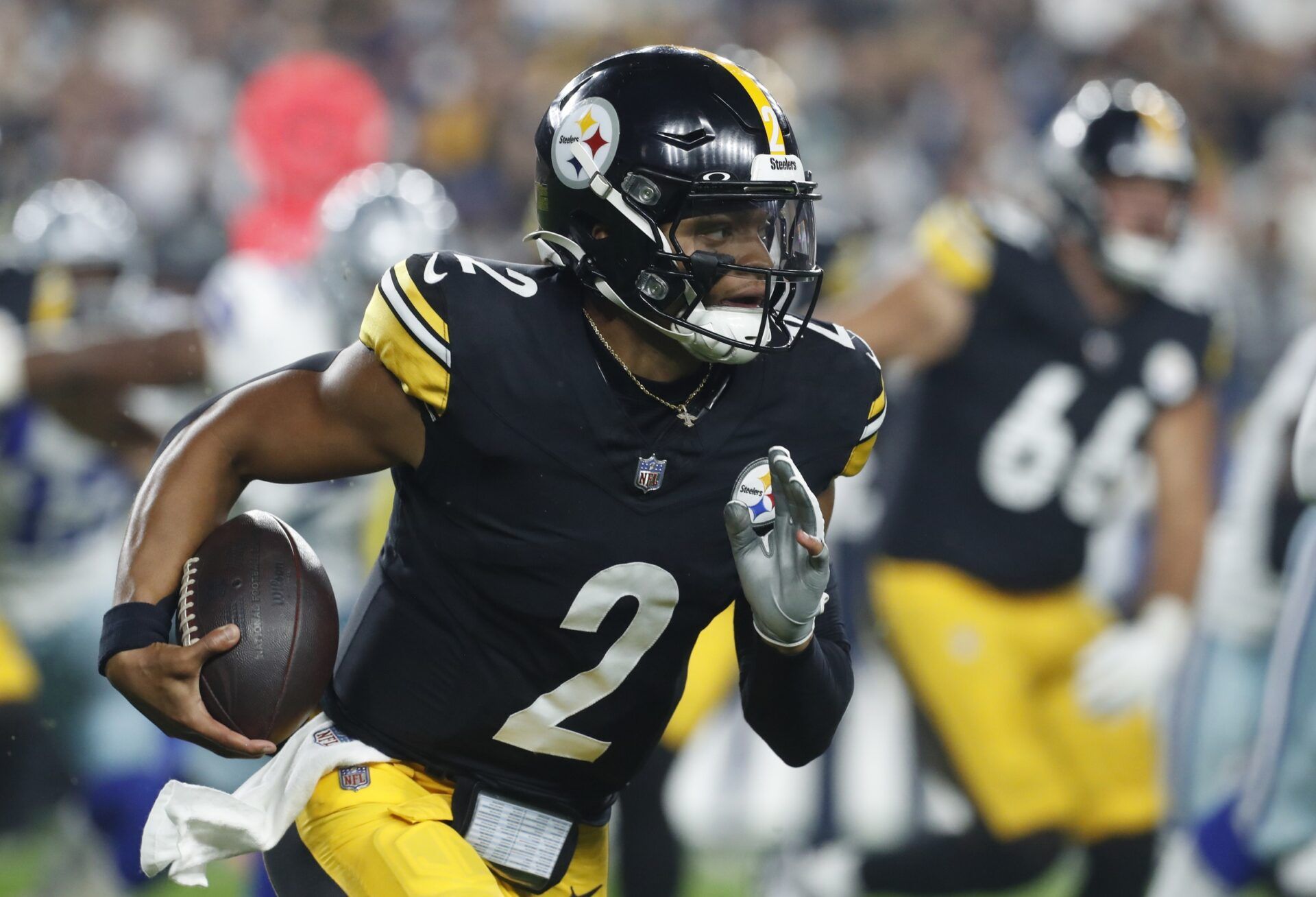 Pittsburgh Steelers quarterback Justin Fields (2) runs the ball against the Dallas Cowboys during the first quarter at Acrisure Stadium.