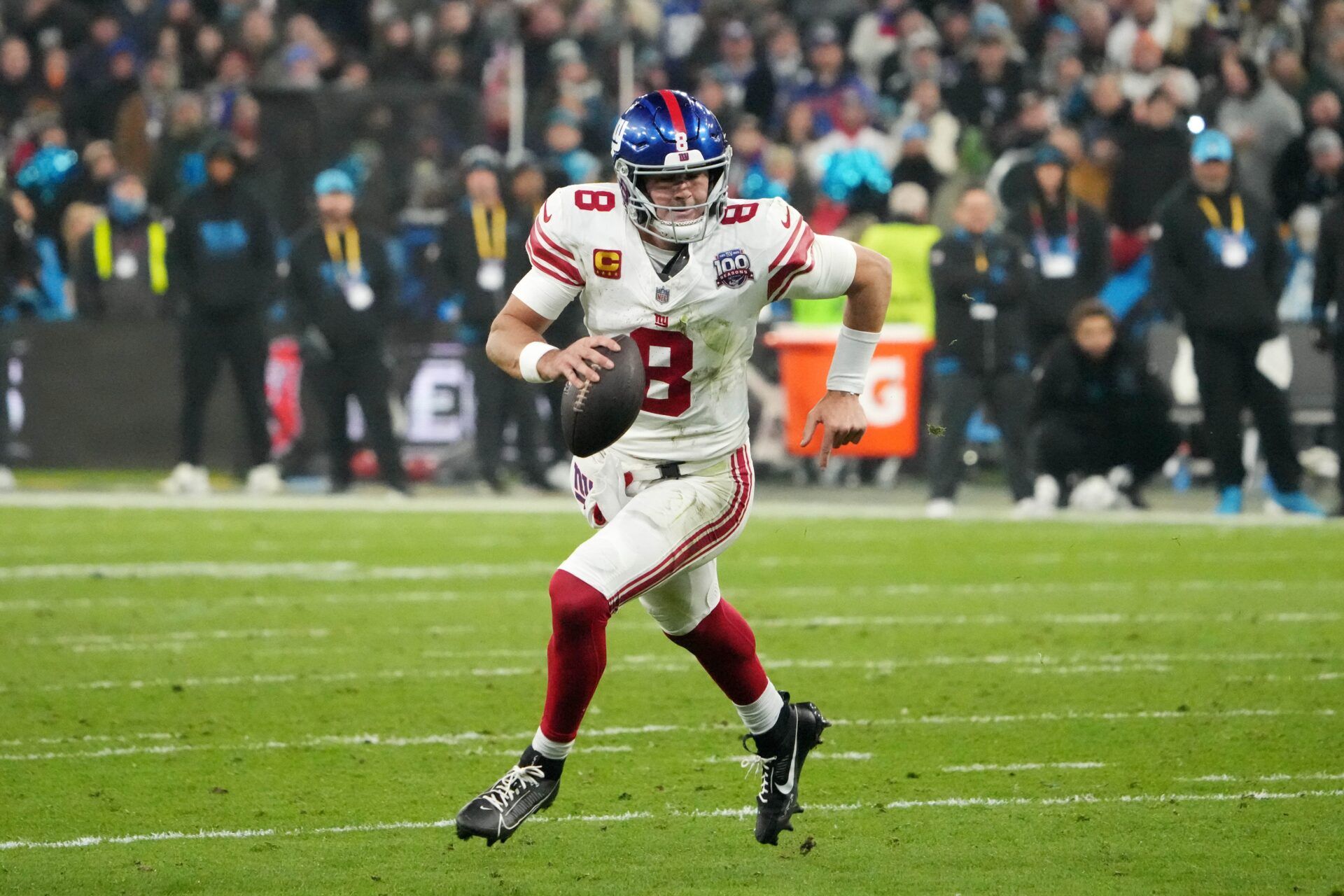 New York Giants quarterback Daniel Jones (8) carries the ball against the New York Giants in the second half during the 2024 NFL Munich Game at Allianz Arena.