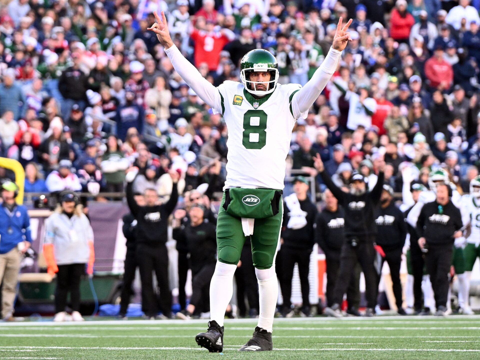 New York Jets quarterback Aaron Rodgers (8) reacts after throwing for a touchdown against the New England Patriots during the second half at Gillette Stadium.