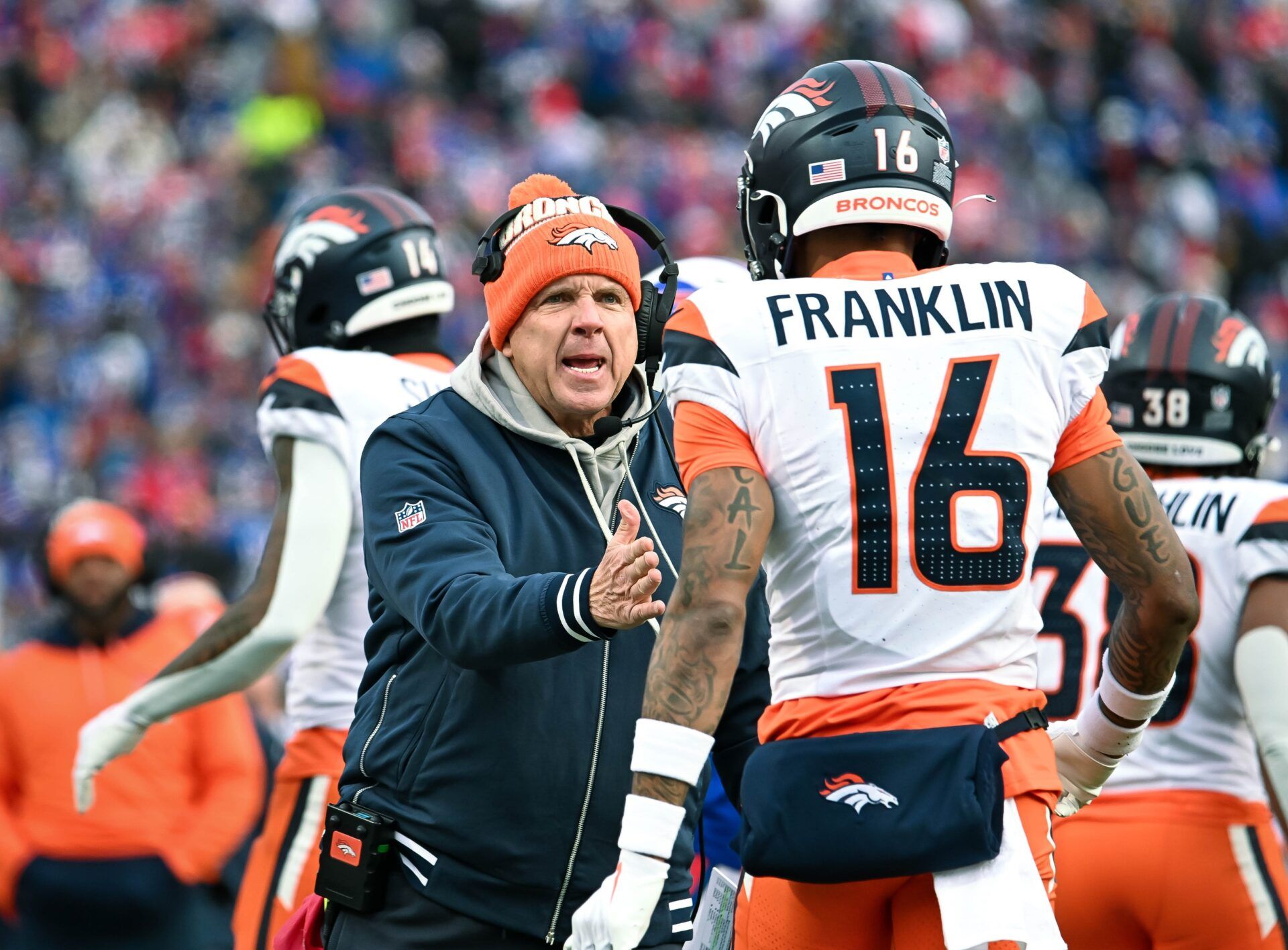 Denver Broncos head coach Sean Payton has a word with wide receiver Troy Franklin (16) in the fourth quarter of an AFC wild card game against the Buffalo Bills at Highmark Stadium.