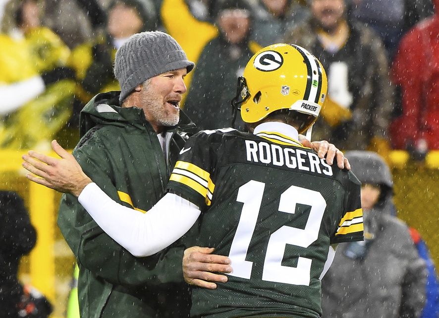 Green Bay Packers former quarterback Brett Favre hugs Green Bay Packers quarterback Aaron Rodgers (12) at half time for a NFL game against the Chicago Bears on Thanksgiving at Lambeau Field.