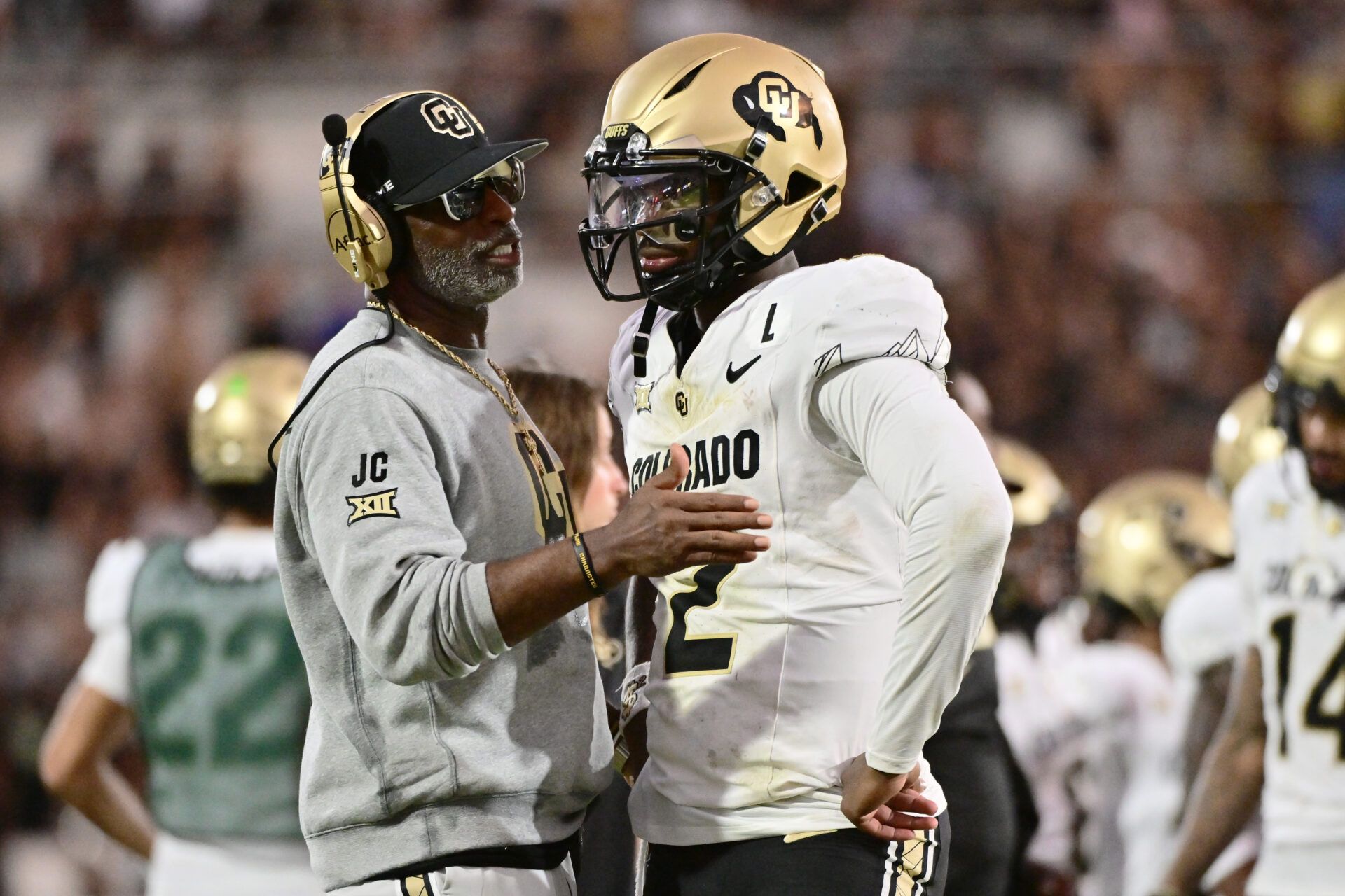 ORLANDO, FLORIDA - SEPTEMBER 28: Head coach Deion Sanders of the Colorado Buffaloes talks with Shedeur Sanders #2 during the second half of a game against the UCF Knights at FBC Mortgage Stadium on September 28, 2024 in Orlando, Florida. (Photo by Julio Aguilar/Getty Images)