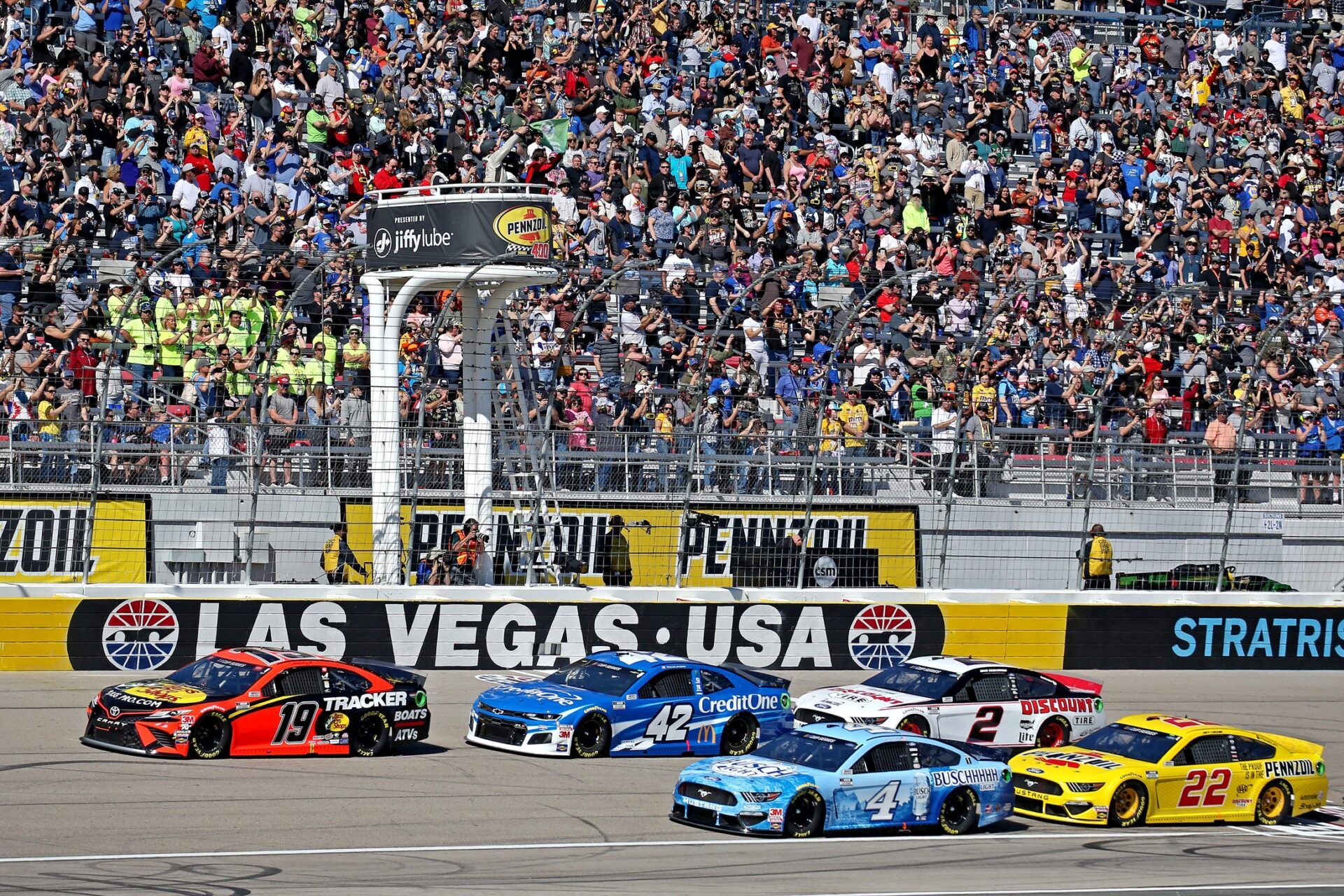 NASCAR Cup Series driver Martin Truex Jr. (19) and NASCAR Cup Series driver Kevin Harvick (4) lead the start of the Pennzoil 400 presented by Jiffy Lube at Las Vegas Motor Speedway.