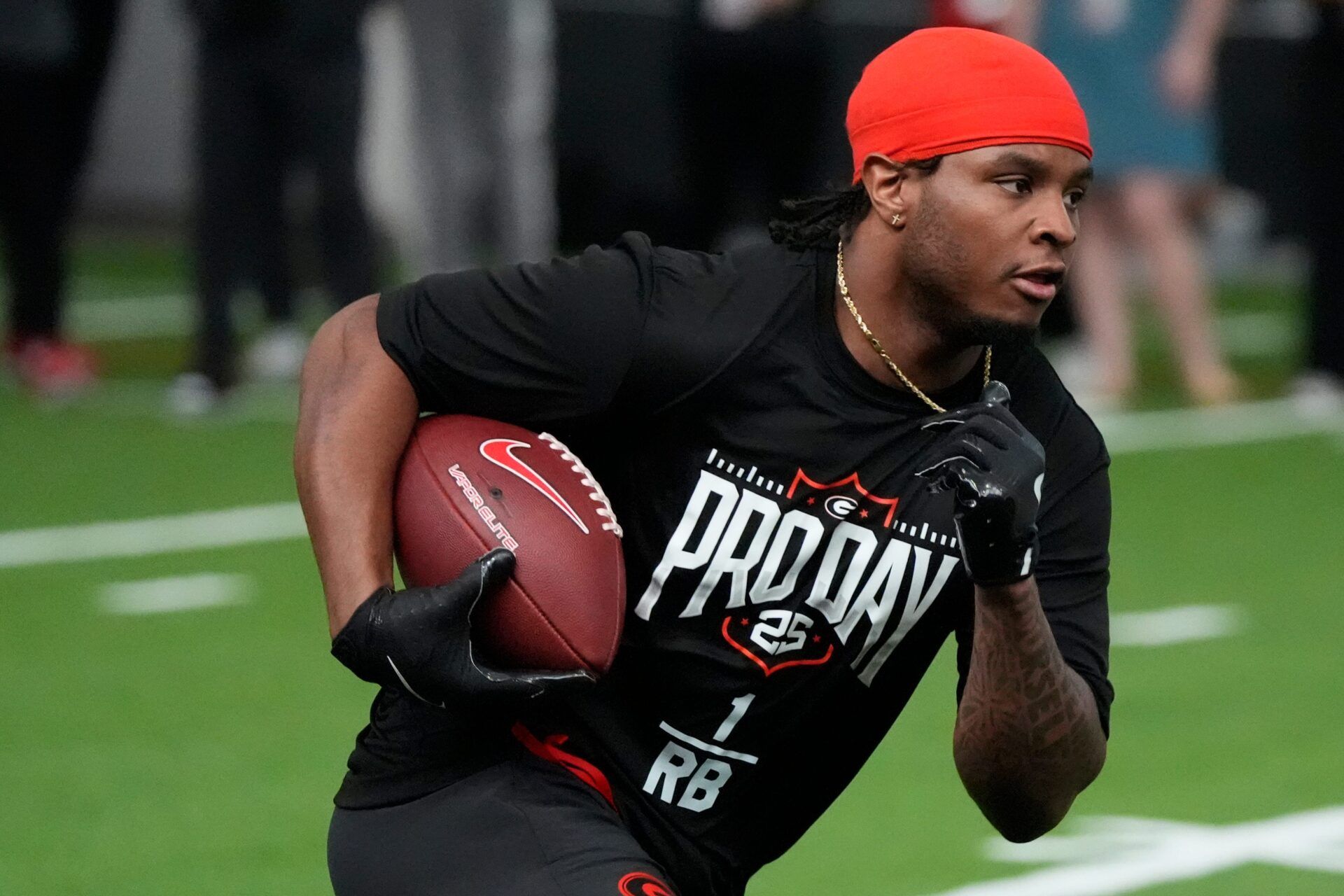 Former Georgia running back Trevor Etienne (1) runs a drill during UGA Footballs Pro Day in Athens, Ga., on Wednesday, March 12, 2025. Representatives from all 32 NFL teams are on hand to watch former UGA football players in action.