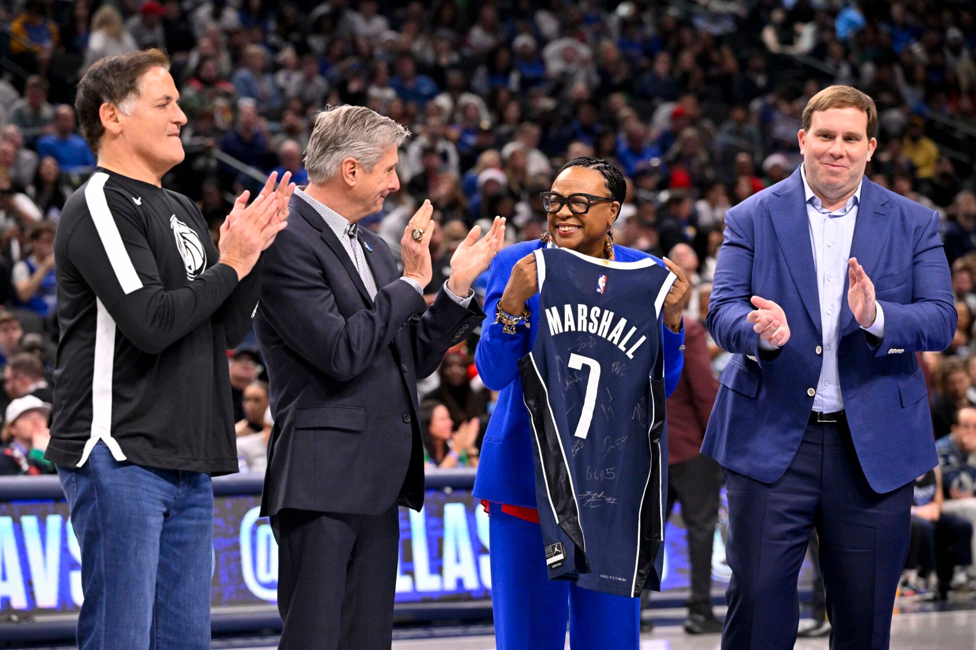 Dec 25, 2024; Dallas, Texas, USA; (from left) Mark Cuban and new Dallas Mavericks CEO Rick Welts and retiring Mavericks CEO Cynt Marshall and Mavericks governor Patrick Dumont present Marshall with a commerative jersey during the game between the Dallas Mavericks and the Minnesota Timberwolves at the American Airlines Center when Luka Dončić was still with the Mavs. Mandatory Credit: Jerome Miron-Imagn Images