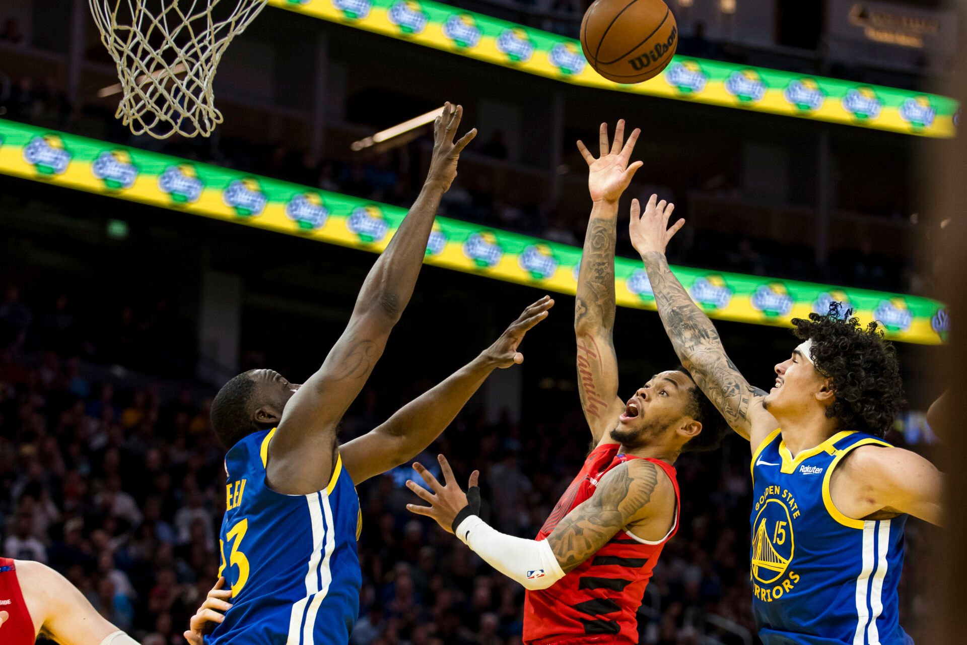 Mar 10, 2025; San Francisco, California, USA; Portland Trail Blazers guard Anfernee Simons (1) shoots as Golden State Warriors forward Draymond Green (23) and forward Gui Santos (15) defend during the fourth quarter at Chase Center. Mandatory Credit: John Hefti-Imagn Images