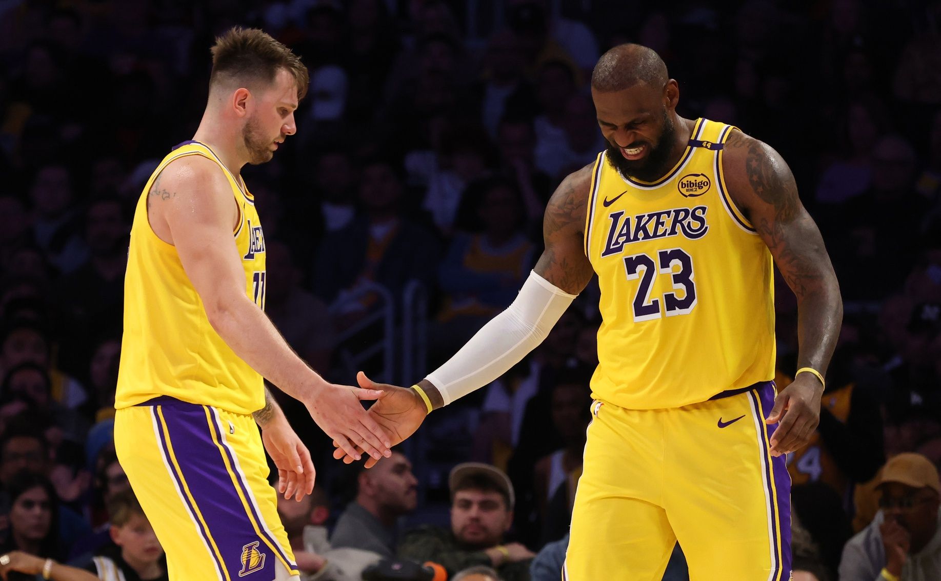 Los Angeles Lakers guard Luka Doncic (77) and forward LeBron James (23) celebrate after a play during the fourth quarter against the Minnesota Timberwolves at Crypto.com Arena.