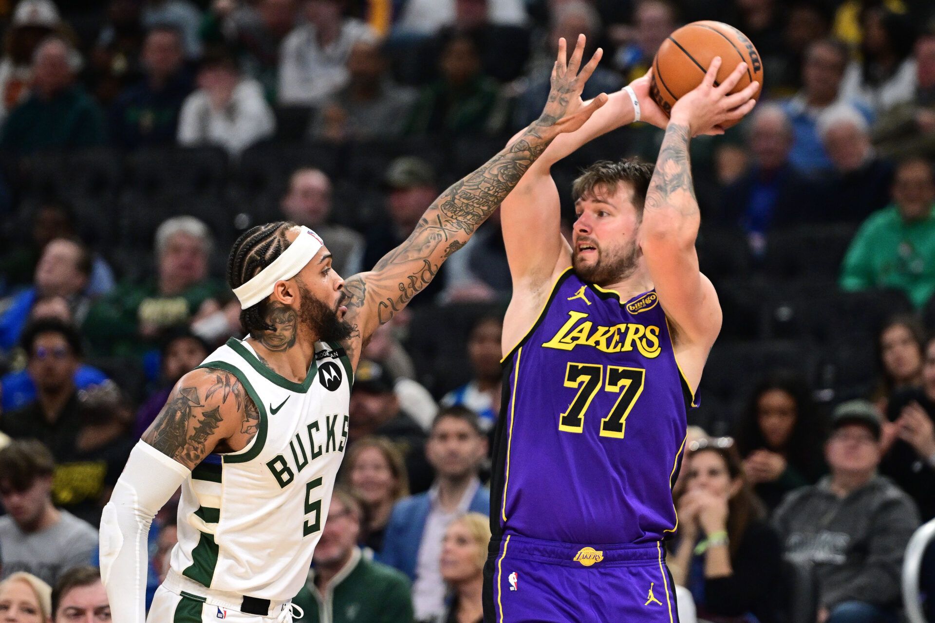 Mar 13, 2025; Milwaukee, Wisconsin, USA; Milwaukee Bucks guard Gary Trent Jr. (5) defends Los Angeles Lakers guard Luka Doncic (77) in the fourth quarter at Fiserv Forum. Mandatory Credit: Benny Sieu-Imagn Images