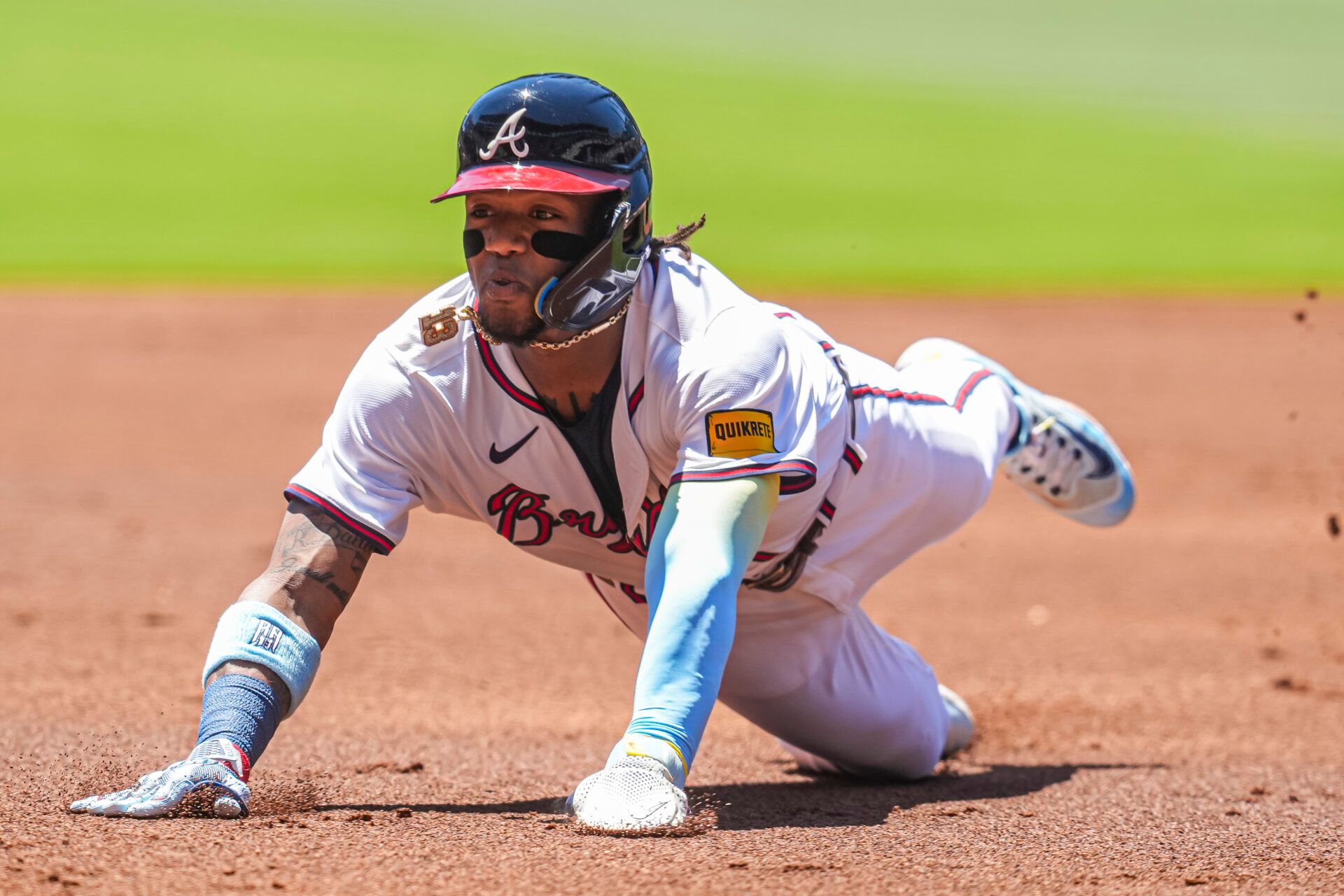 May 20, 2024; Cumberland, Georgia, USA; Atlanta Braves right fielder Ronald Acuna Jr (13) slides into third base against the San Diego Padres during the first inning at Truist Park. Mandatory Credit: Dale Zanine-USA TODAY Sports