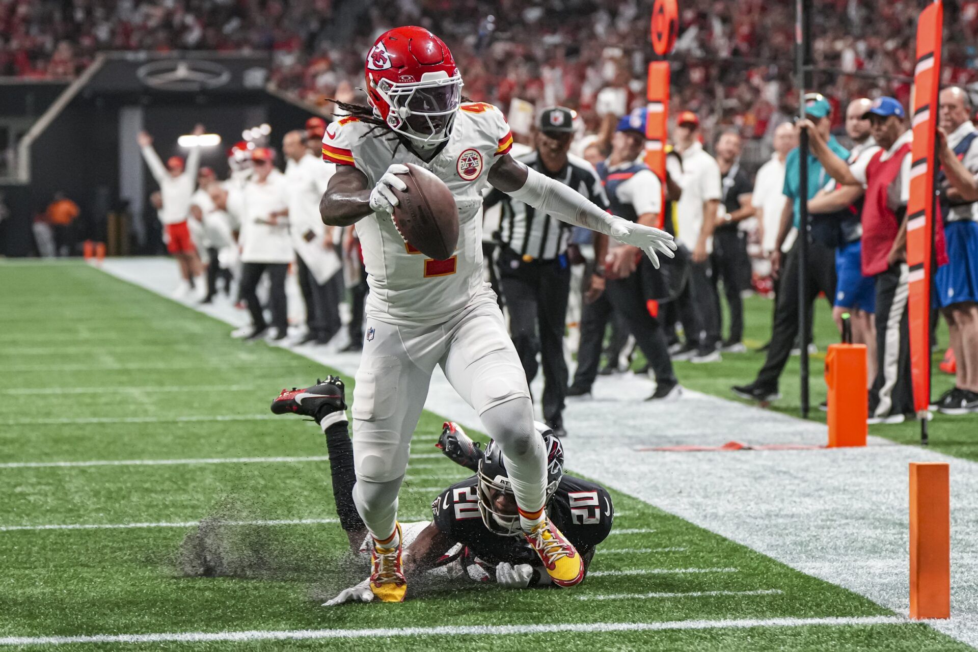 Kansas City Chiefs wide receiver Rashee Rice (4) scores a touchdown past Atlanta Falcons cornerback Dee Alford (20) during the first half at Mercedes-Benz Stadium.