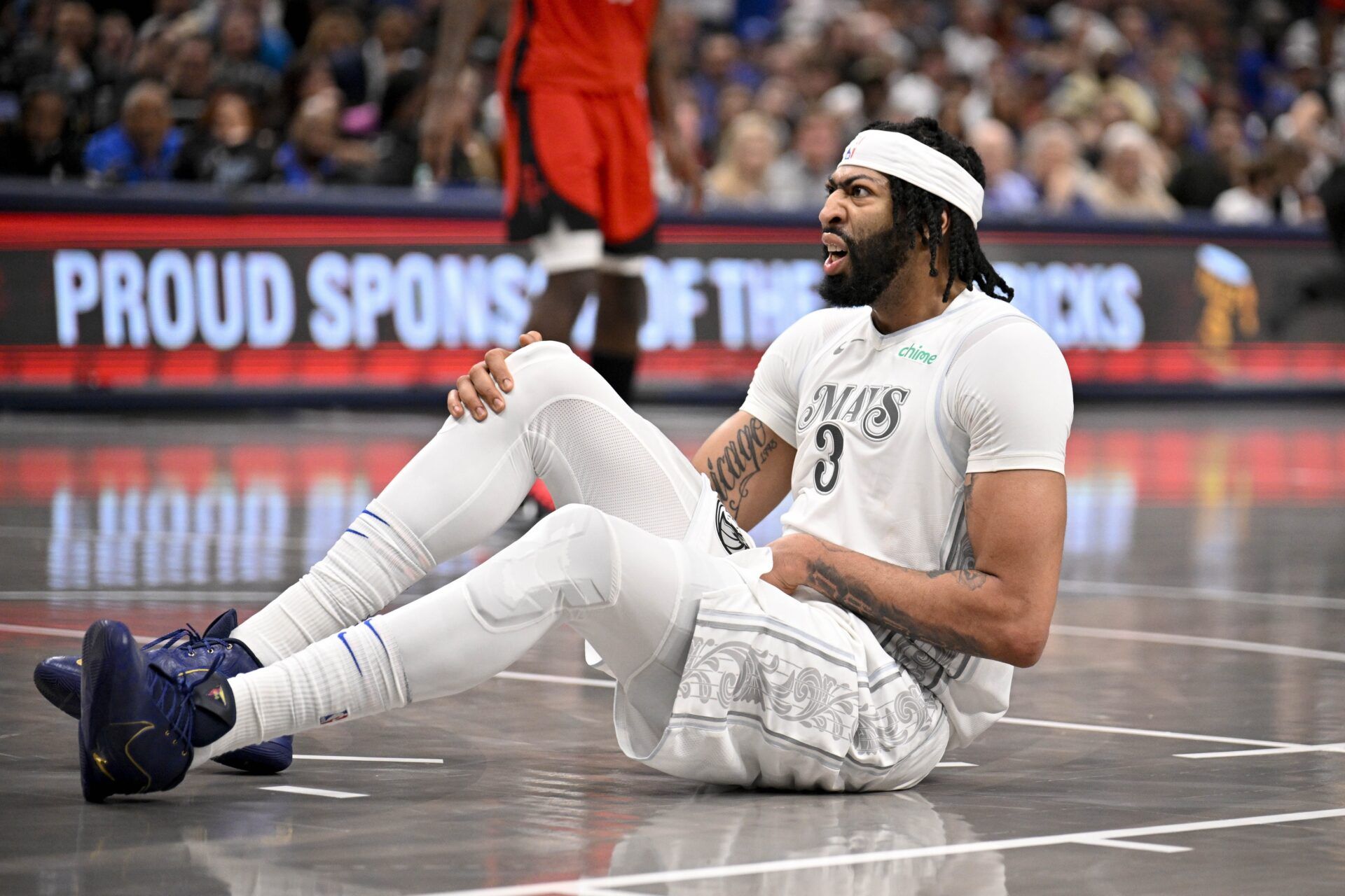 Dallas Mavericks forward Anthony Davis (3) grabs his midsection with an apparent injury during the game between the Dallas Mavericks and the Houston Rockets at the American Airlines Center.