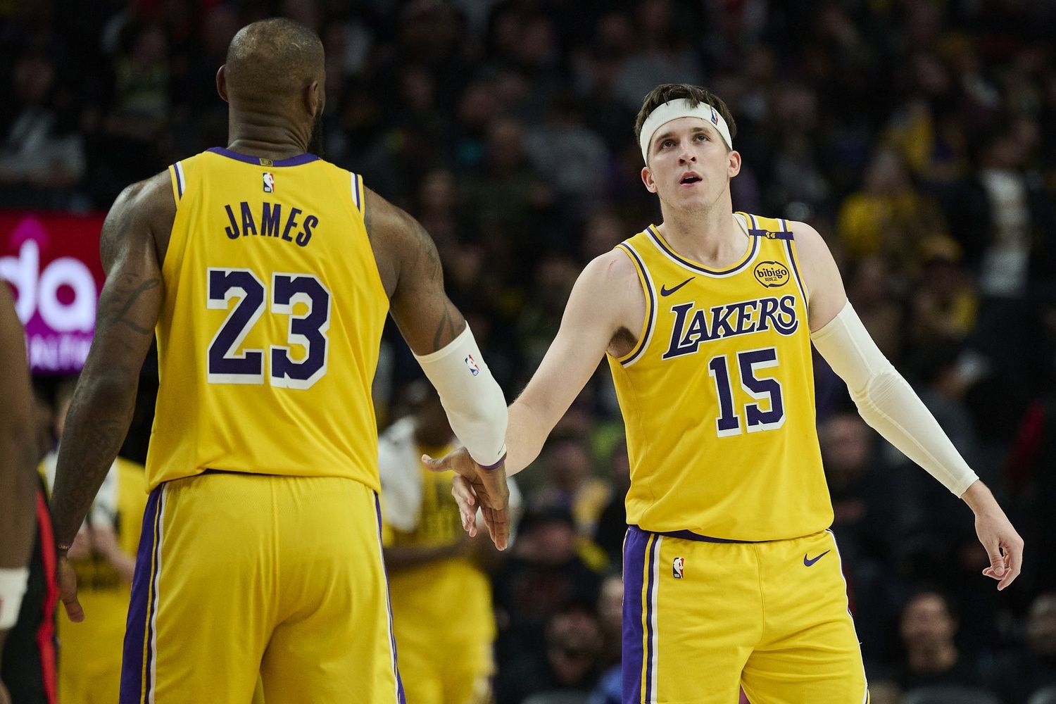 Los Angeles Lakers guard Austin Reaves (15) high fives forward LeBron James (23) during the second half against the Portland Trail Blazers at Moda Center.