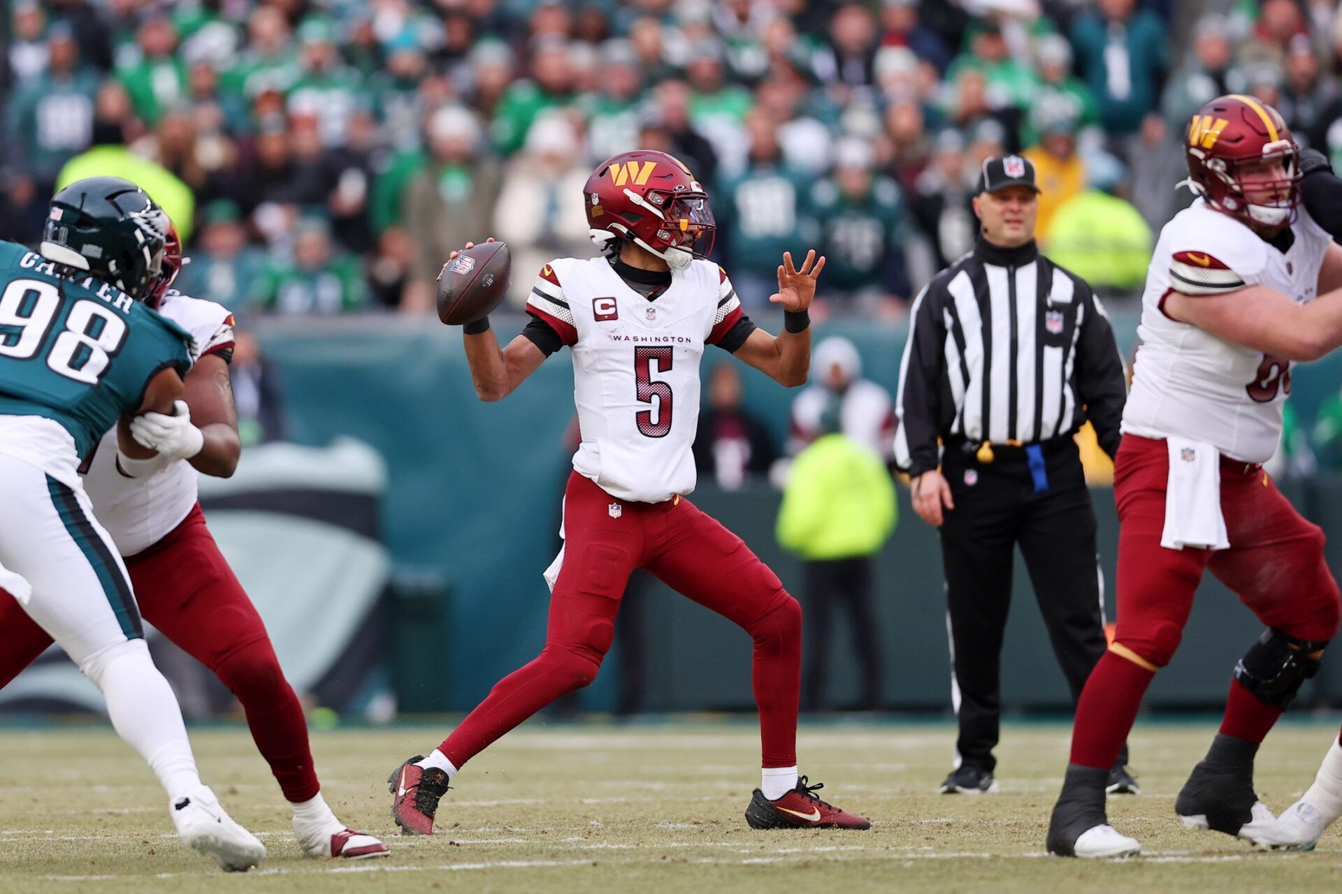 Washington Commanders quarterback Jayden Daniels (5) looks to pass the ball against the Philadelphia Eagles during the first half of the NFC Championship game at Lincoln Financial Field.