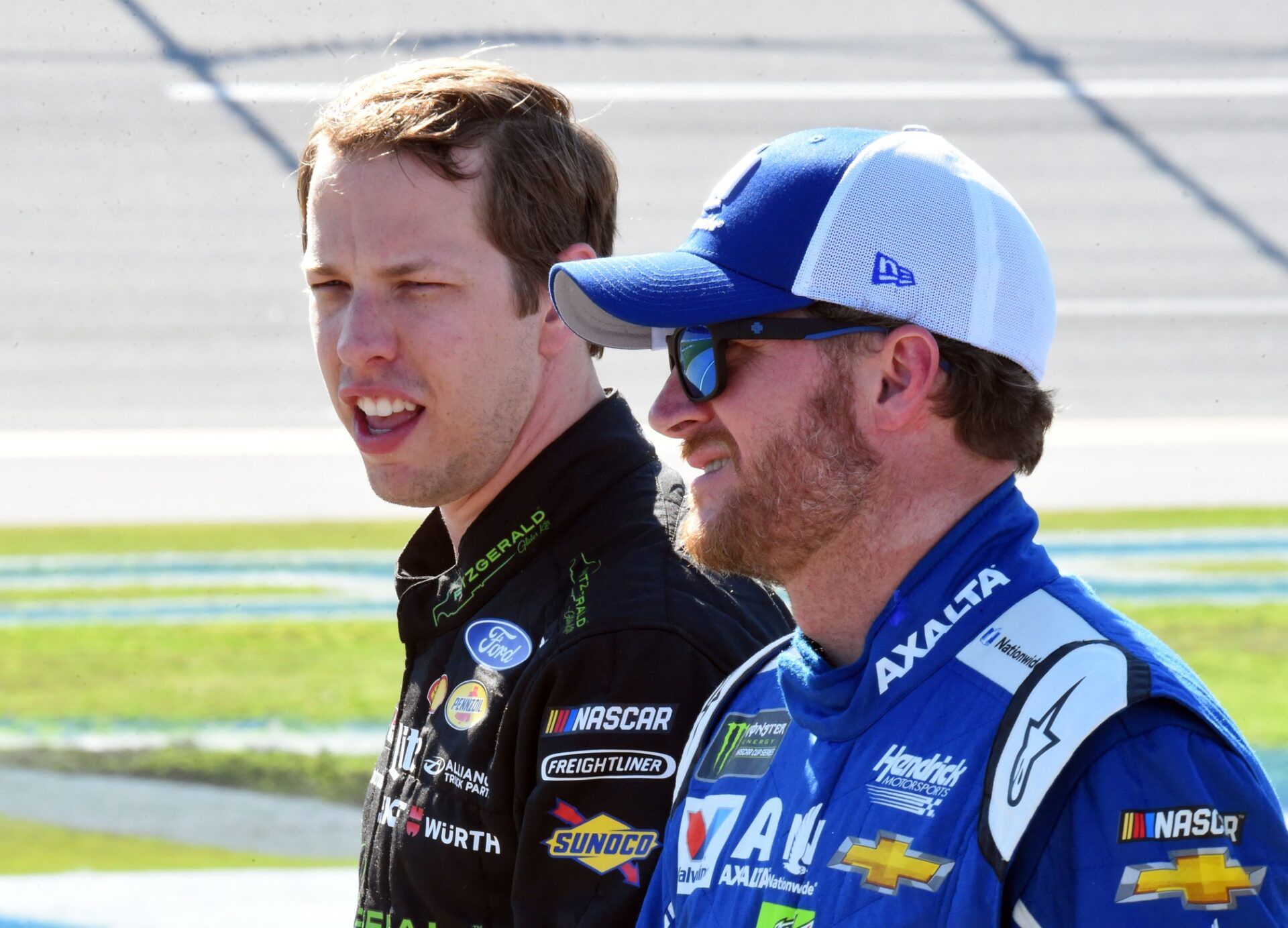 NASCAR Cup Series driver Brad Keselowski (2) talks with Dale Earnhardt Jr. (88) during qualifying for the GEICO 500 at Talladega Superspeedway.