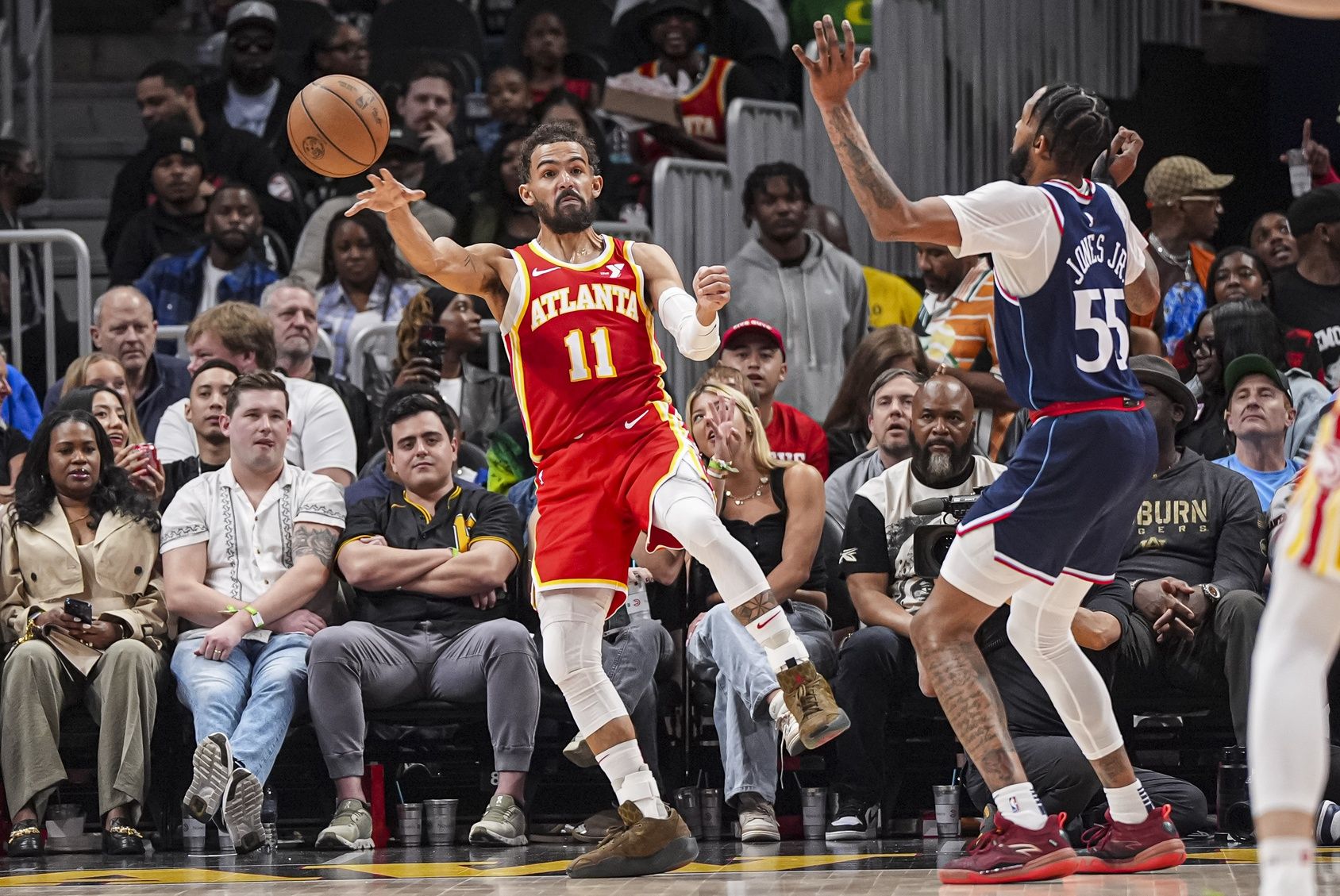 Atlanta Hawks guard Trae Young (11) passes against LA Clippers forward Derrick Jones Jr. (55) during the second half at State Farm Arena.