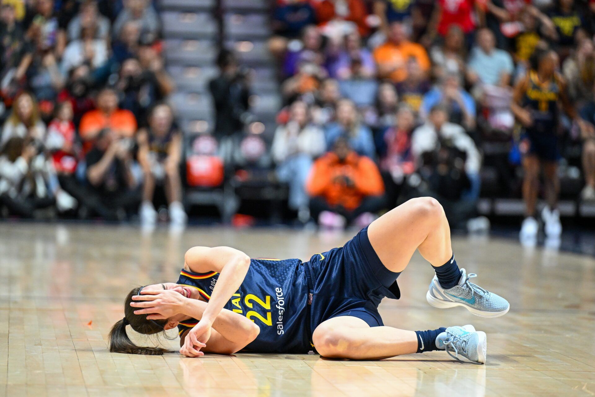 Indiana Fever guard Caitlin Clark (22) reacts to a foul in the first quarter during game one of the first round of the 2024 WNBA Playoffs at Mohegan Sun Arena.