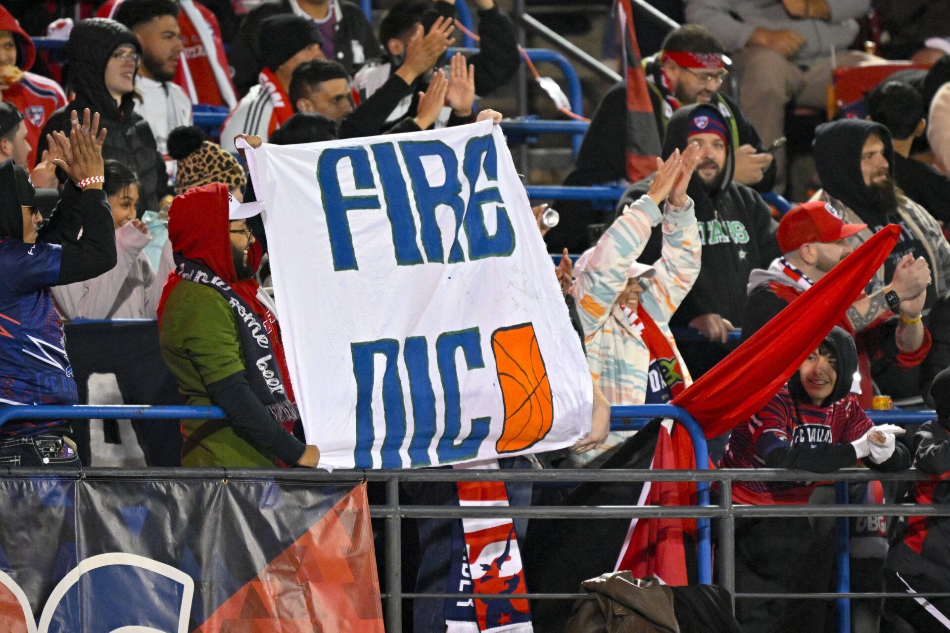 FC Dallas fans hold up a Fire Nico sign for Dallas Mavericks general manager Nico Harrison during the first half of the game between FC Dallas and Chicago Fire at Toyota Stadium.