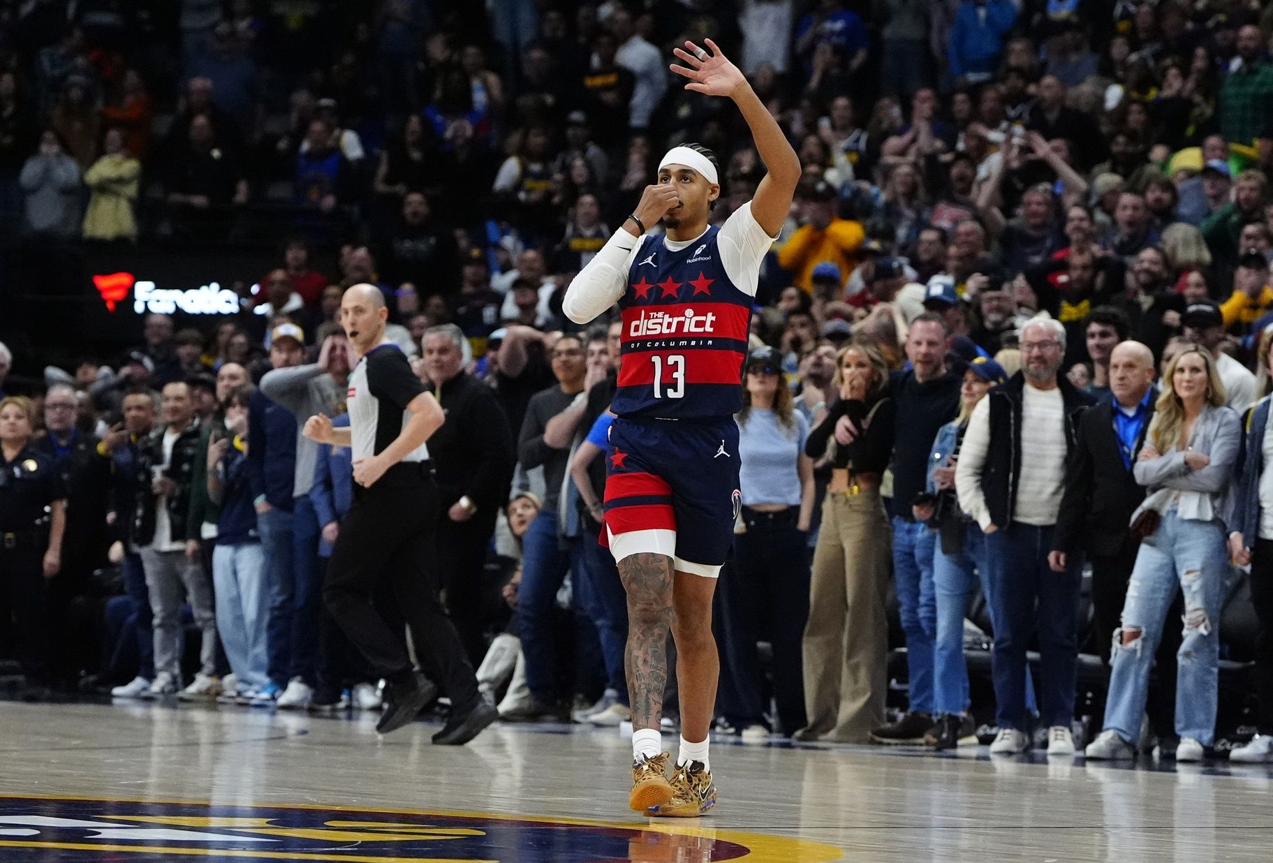 Washington Wizards guard Jordan Poole (13) celebrates his game winning three-point basket with forward Kyshawn George (18) in the fourth quarter against the Denver Nuggets at Ball Arena.