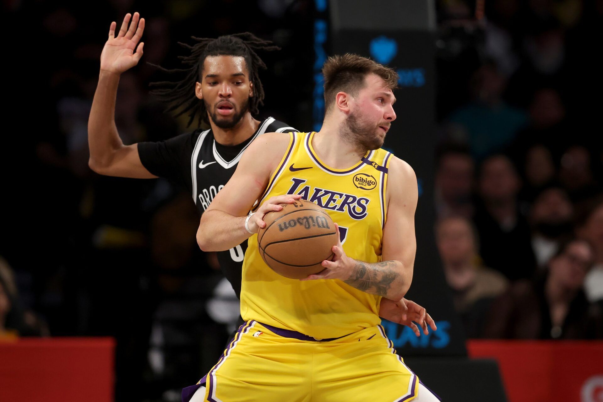 Los Angeles Lakers guard Luka Doncic (77) spins around Brooklyn Nets forward Ziaire Williams (8) during the fourth quarter at Barclays Center.