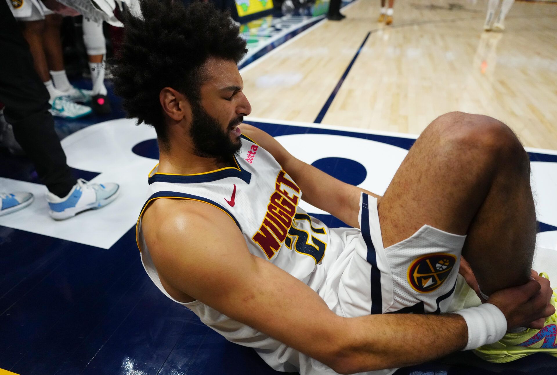 Denver Nuggets guard Jamal Murray (27) reacts on the baseline after a right leg injury in the fourth quarter at Ball Arena. Mandatory Credit: Ron Chenoy-Imagn Images