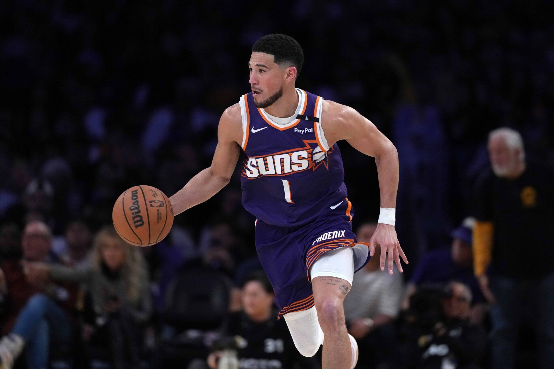 Phoenix Suns guard Devin Booker (1) dribbles the ball against the Los Angeles Lakers in the second half at Crypto.com Arena.