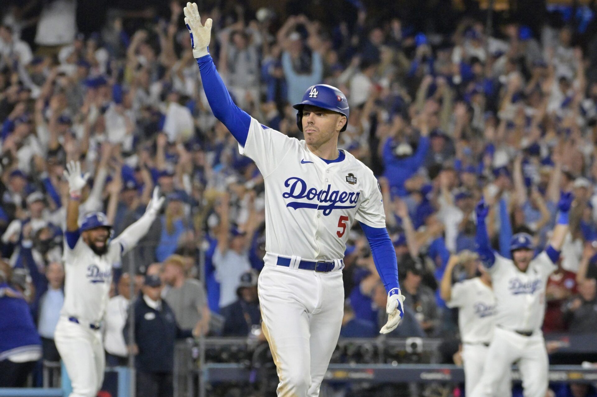 Los Angeles Dodgers first baseman Freddie Freeman (5) celebrates after hitting a grand slam home run in the tenth inning against the New York Yankees during game one of the 2024 MLB World Series at Dodger Stadium.