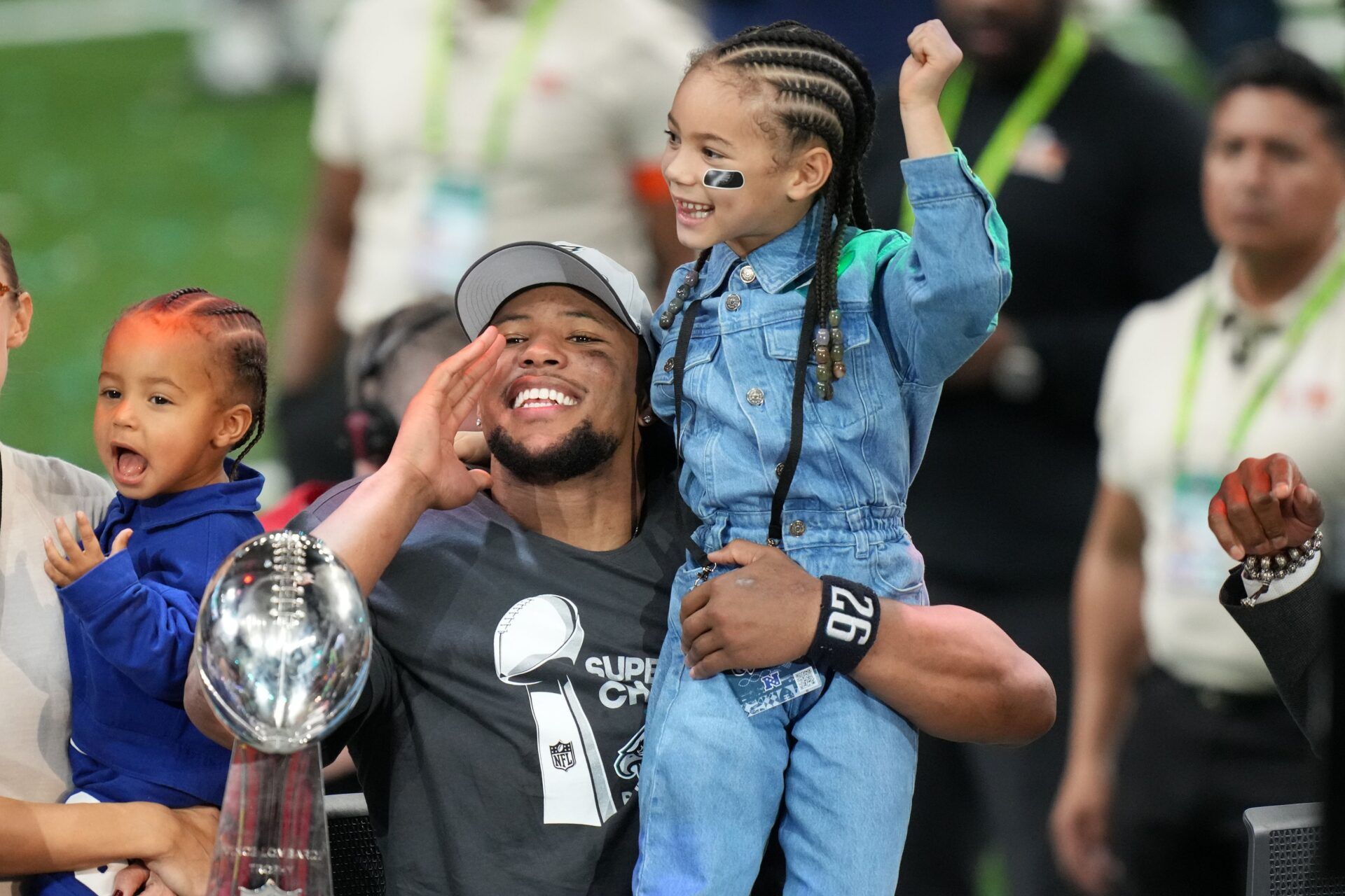 Philadelphia Eagles running back Saquon Barkley (26) talks to the media with his daughter, Jada, after defeating the Kansas City Chiefs in Super Bowl LIX at Caesars Superdome.