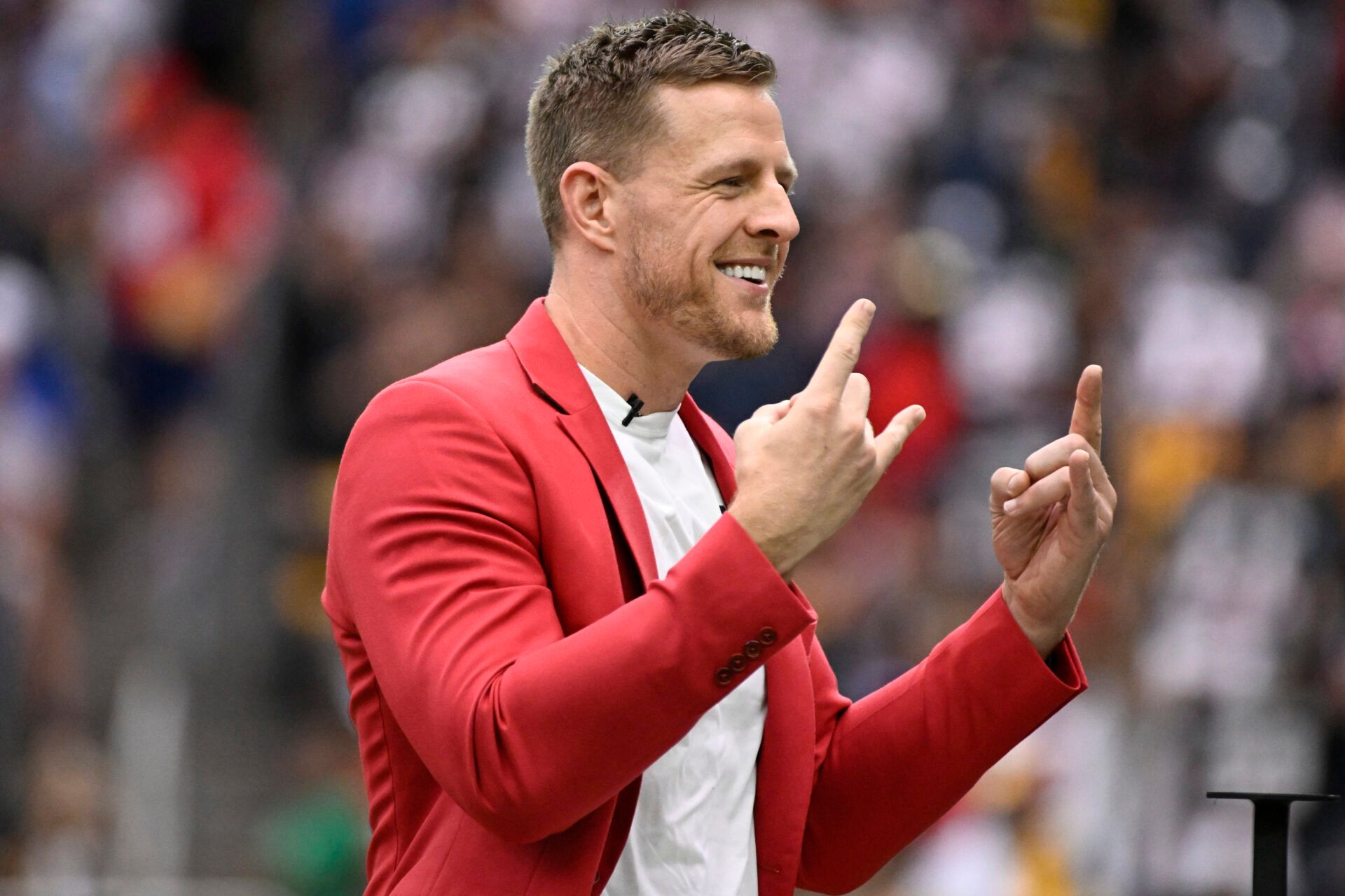 HOUSTON, TEXAS - OCTOBER 01: Former Houston Texans player J.J. Watt waves to the crowd during a ceremony inducting him into the Texans Ring of Honor during a game against the Pittsburgh Steelers at NRG Stadium on October 01, 2023 in Houston, Texas. (Photo by Logan Riely/Getty Images)