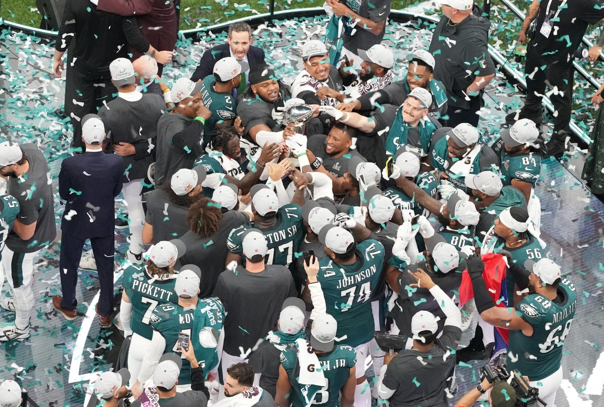 Philadelphia Eagles running back Saquon Barkley (26) holds the Vince Lombardi Trophy with teammates after defeating the Kansas City Chiefs in Super Bowl LIX at Caesars Superdome.