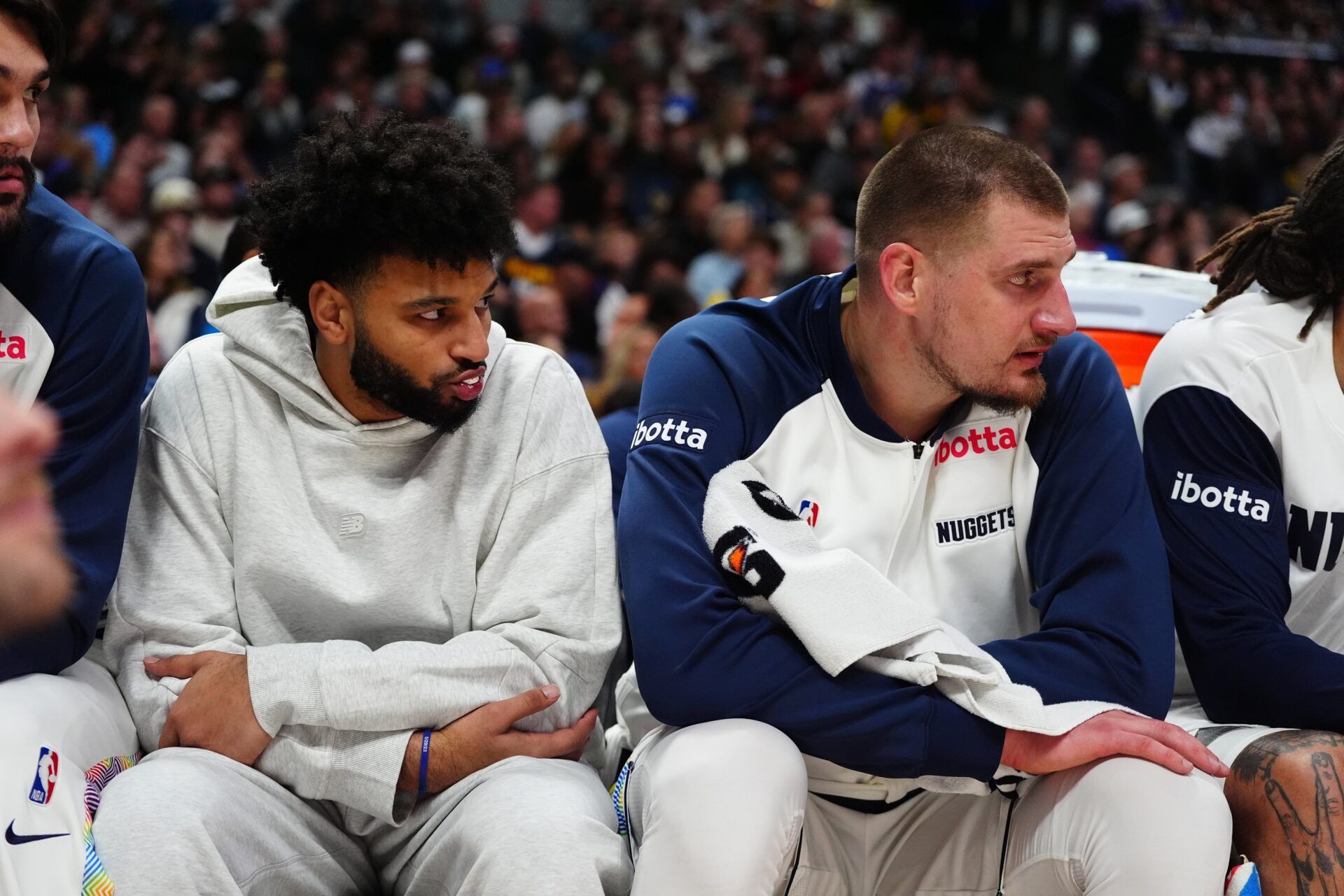 Denver Nuggets center Nikola Jokic (15) and guard Jamal Murray (27) on the bench in the fourth quarter against the Phoenix Suns at Ball Arena.