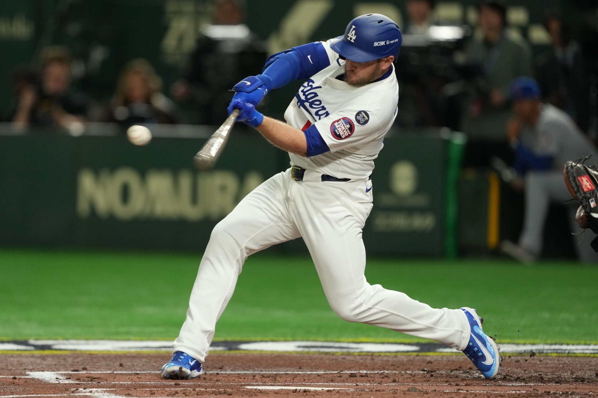 Los Angeles Dodgers third baseman Max Muncy (13) hits a double against teh Chicago Cubs in the second inning during the Tokyo Series at Tokyo Dome.