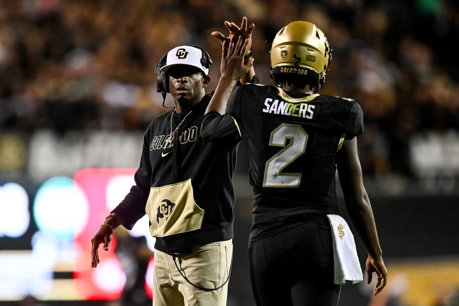 BOULDER, CO - SEPTEMBER 16: Head coach Deion Sanders of the Colorado Buffaloes celebrates with quarterback Shedeur Sanders #2 after a fourth quarter touchdown against the Colorado State Rams at Folsom Field on September 16, 2023 in Boulder, Colorado. (Photo by Dustin Bradford/Getty Images)