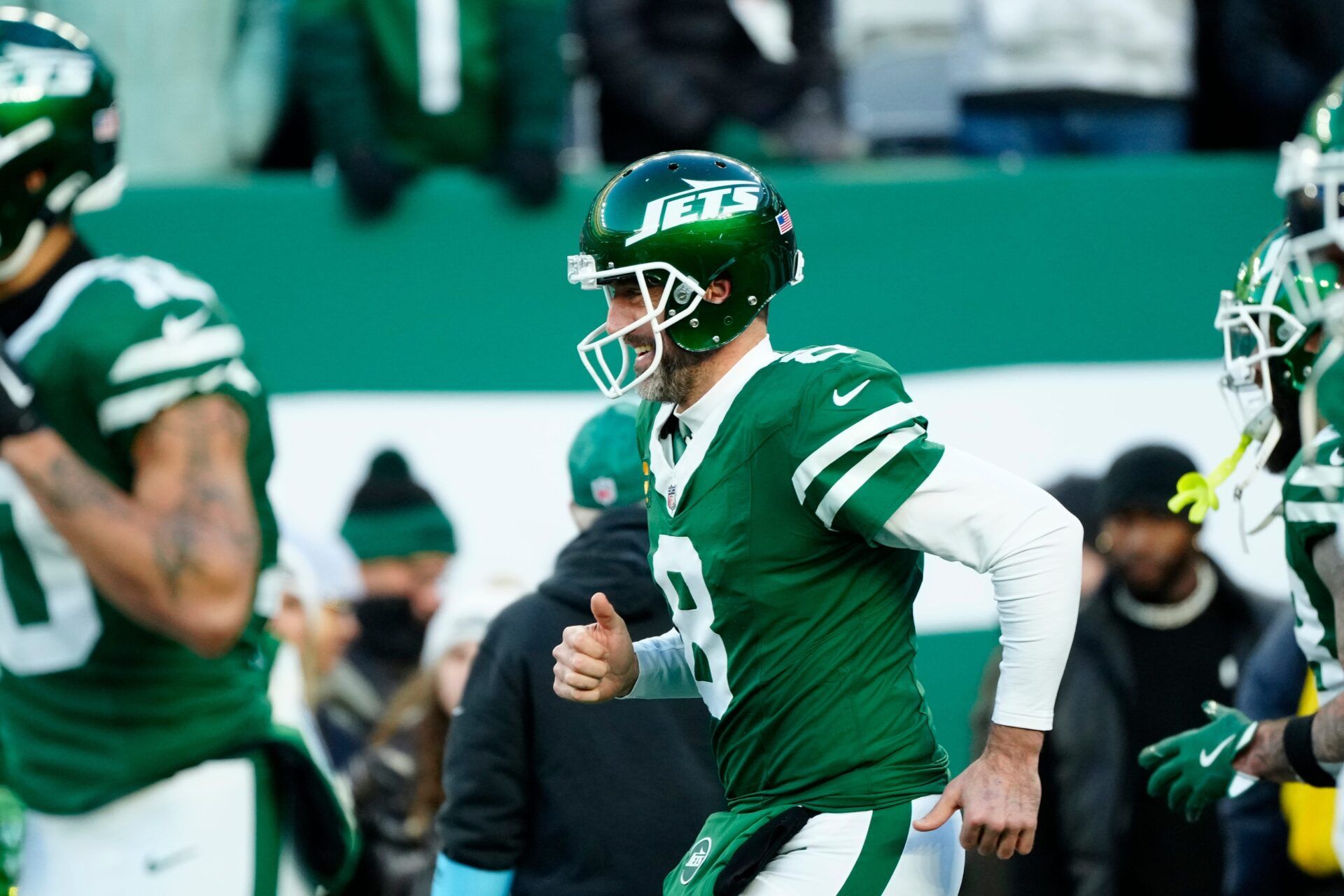 New York Jets quarterback Aaron Rodgers (8) takes the field to warm up before the game, Sunday January 5, 2025, in East Rutherford.