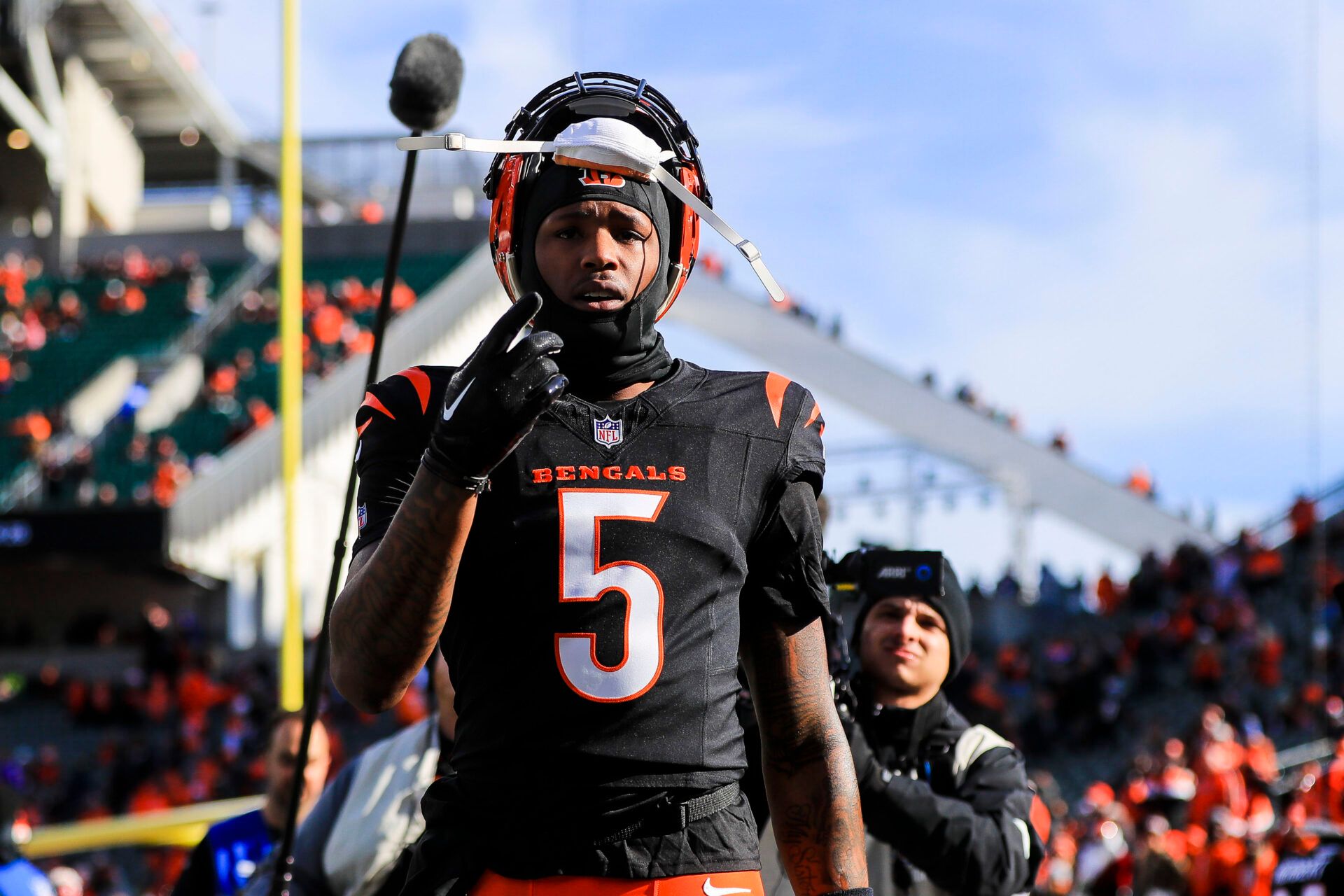 Cincinnati Bengals wide receiver Tee Higgins (5) acknowledges fans during warmups before the game against the Cleveland Browns at Paycor Stadium.