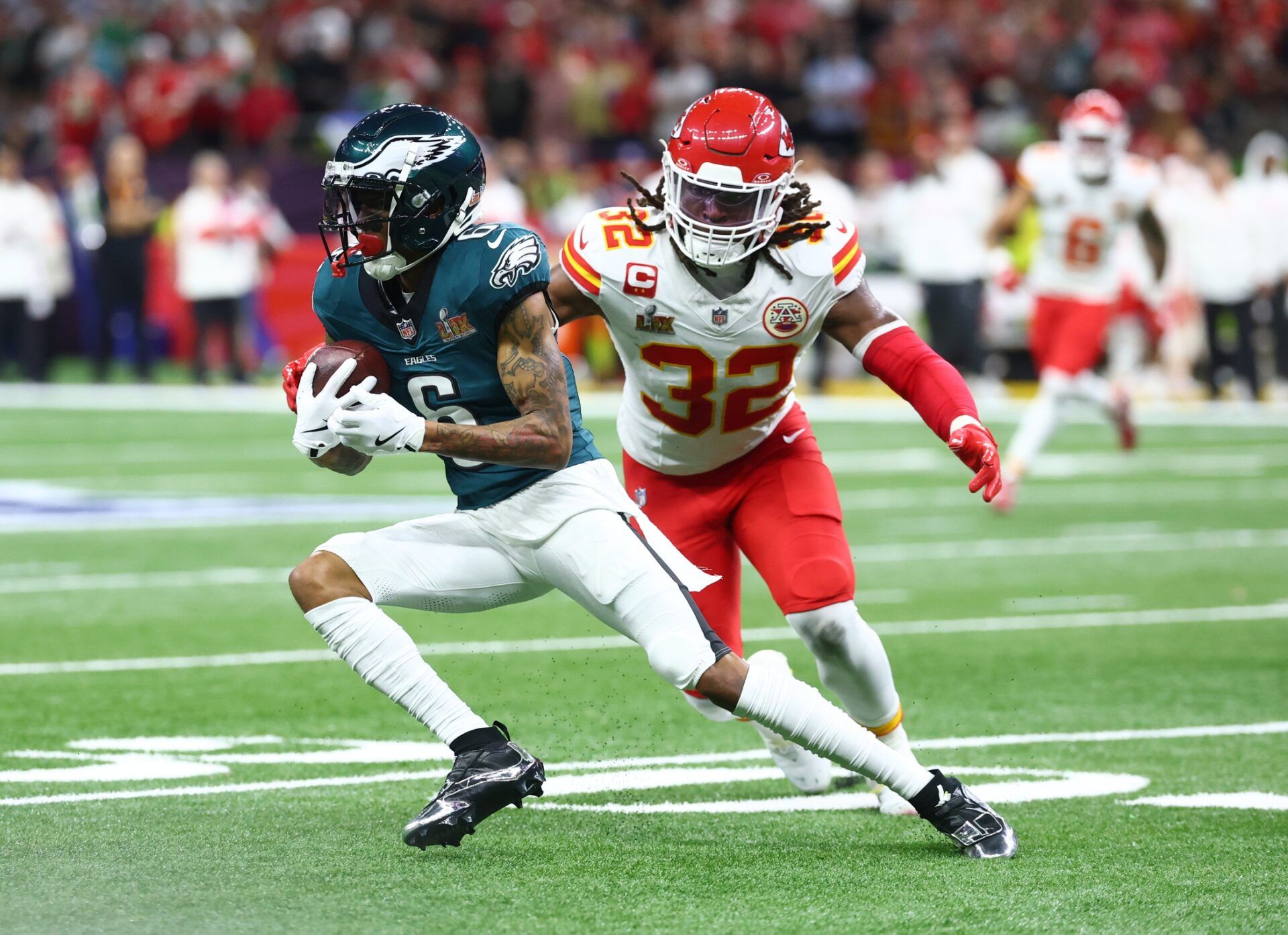 Philadelphia Eagles wide receiver DeVonta Smith (6) makes a catch against Kansas City Chiefs linebacker Nick Bolton (32) in the first quarter in Super Bowl LIX at Ceasars Superdome.