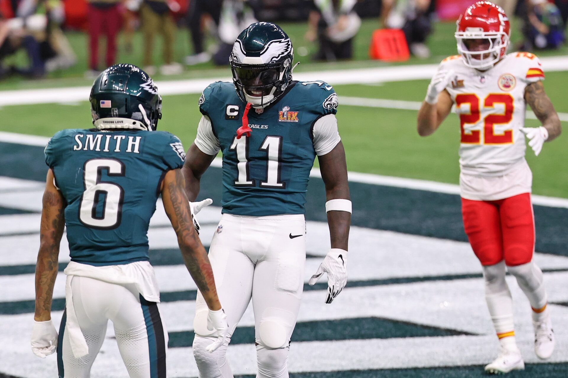 Philadelphia Eagles wide receiver A.J. Brown (11) congratulates wide receiver DeVonta Smith (6) after he scored a touchdown against the Kansas City Chiefs during the second half of Super Bowl LIX at Caesars Superdome.