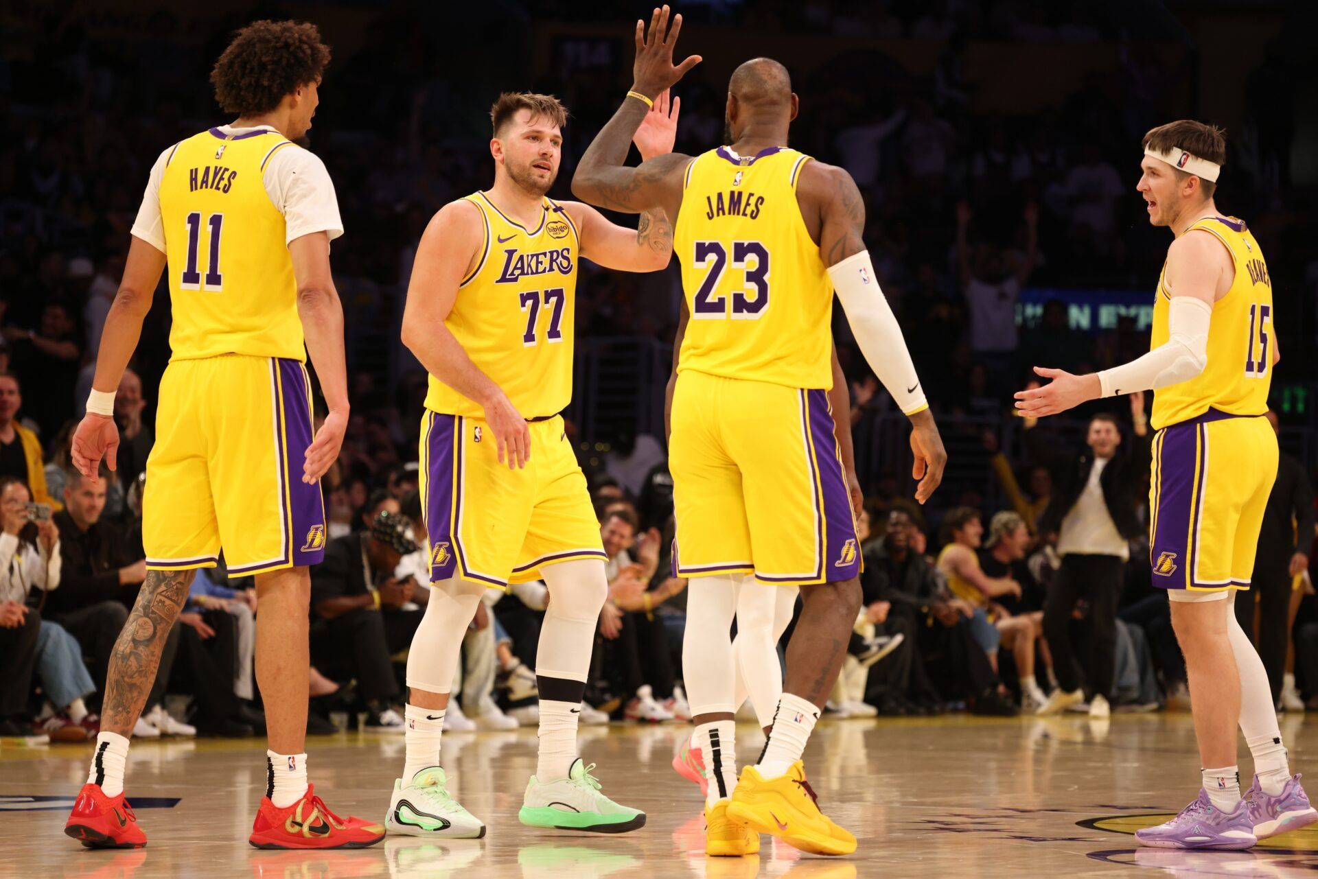 Los Angeles Lakers guard Luka Doncic (77) celebrates with forward LeBron James (23) after making a basket during the fourth quarter against the Minnesota Timberwolves at Crypto.com Arena.