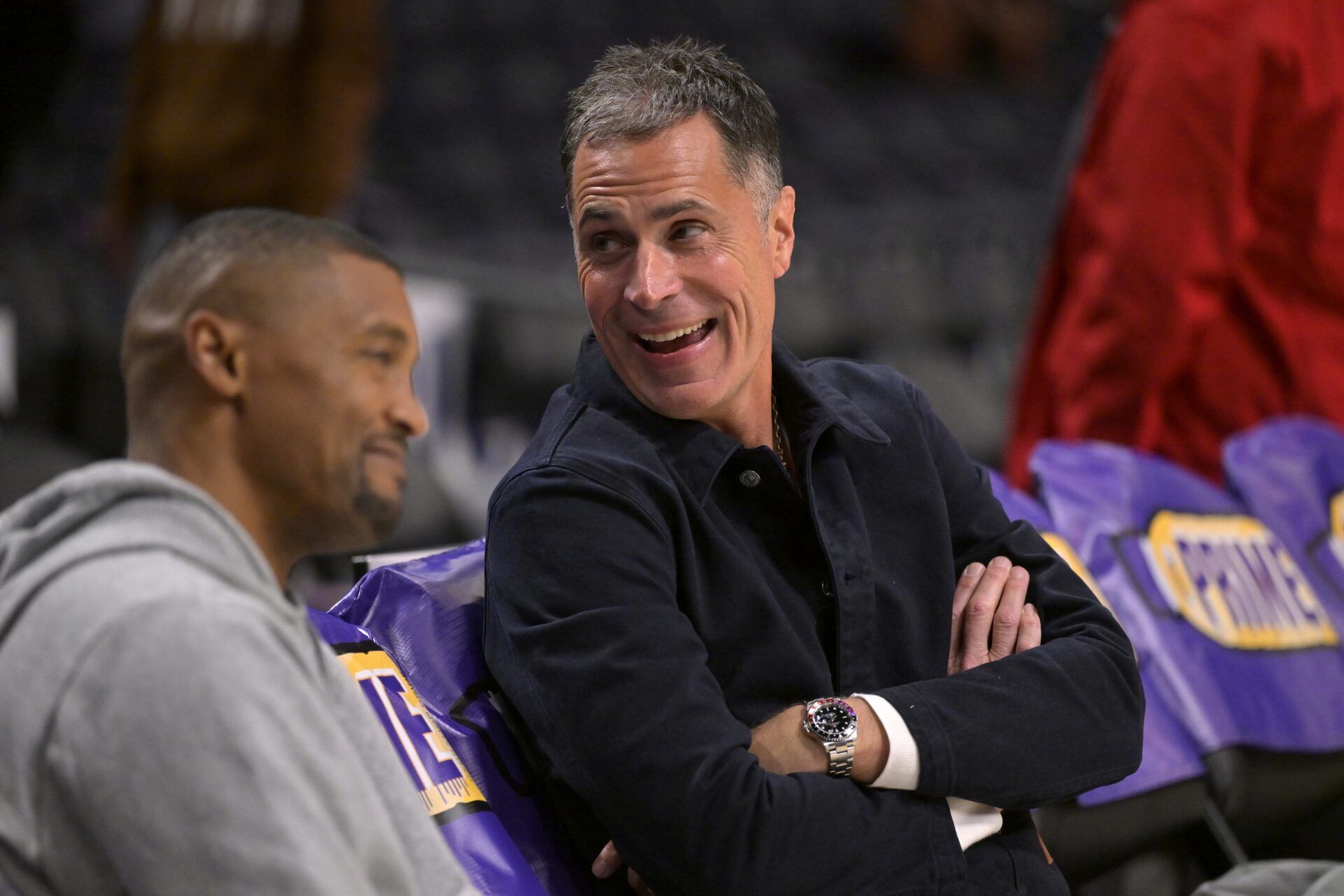 Los Angeles Lakers general manager Rob Pelinka, right, talks with Leroy Sims, director of player performance & health, prior to the game against the Orlando Magic at Crypto.com Arena.