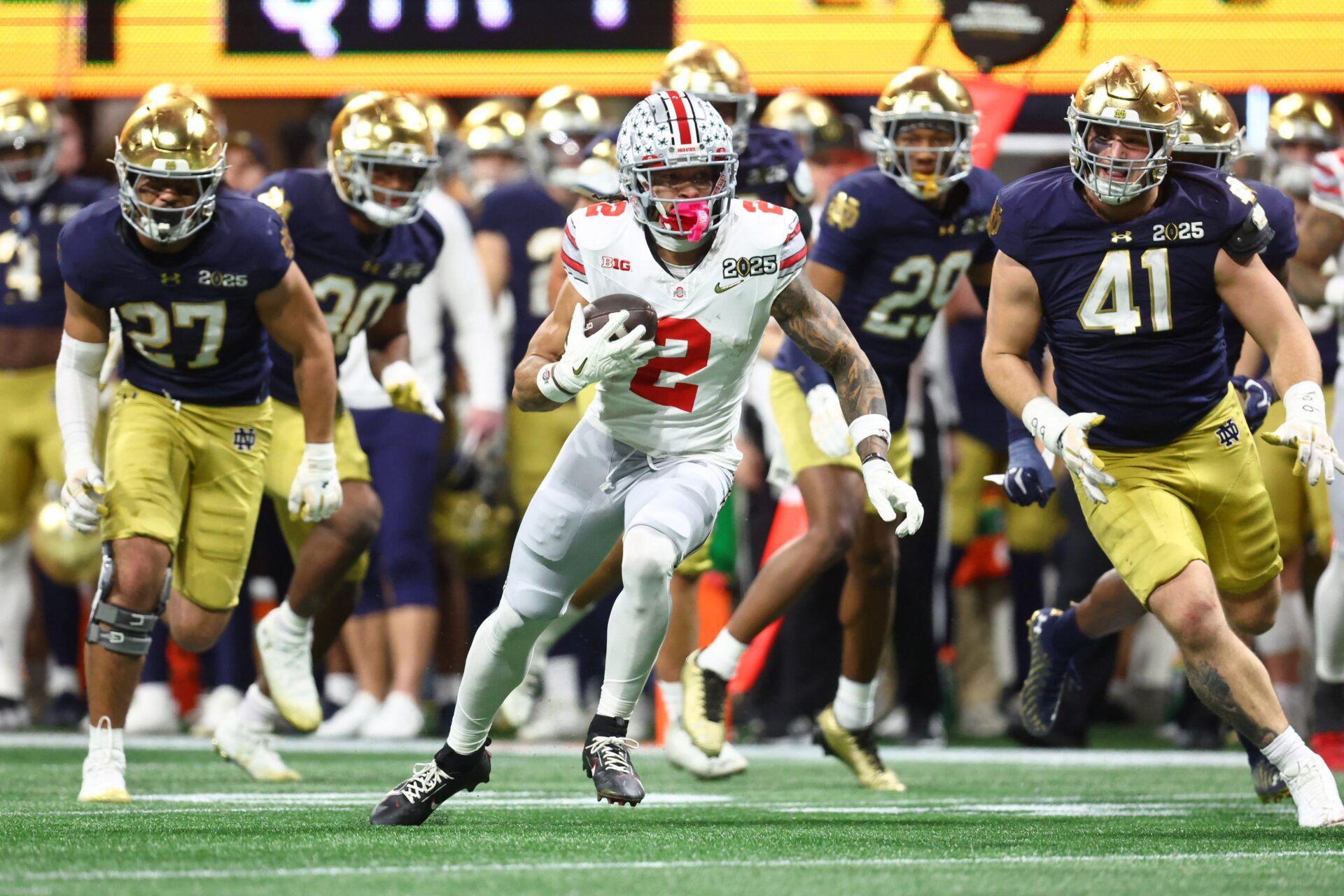 Ohio State Buckeyes wide receiver Emeka Egbuka (2) runs with the ball against the Notre Dame Fighting Irish during the second half the CFP National Championship college football game at Mercedes-Benz Stadium.