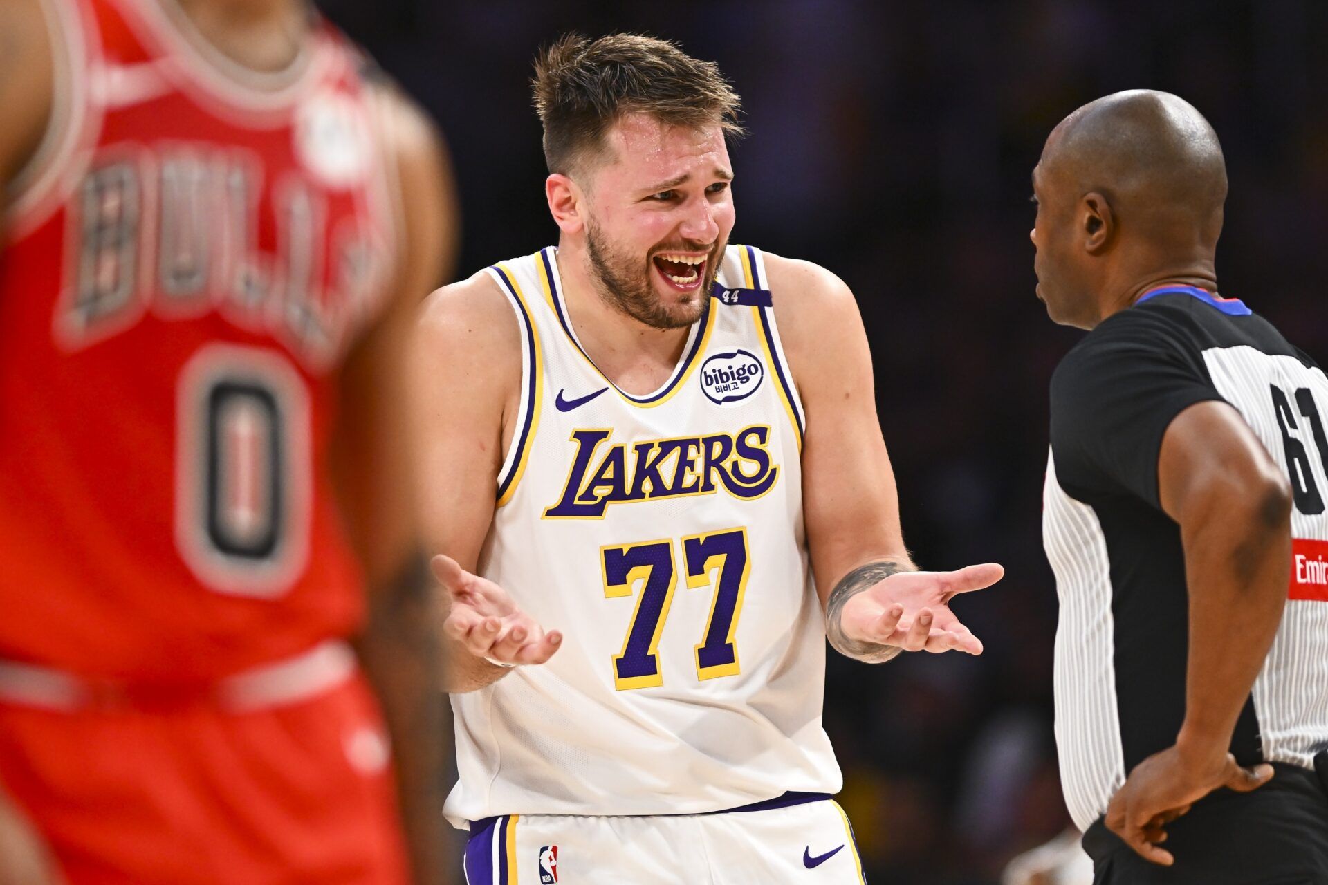 Los Angeles Lakers guard Luka Doncic (77) reacts to a call from referee Courtney Kirkland (61) against the Chicago Bulls during the second half at Crypto.com Arena.