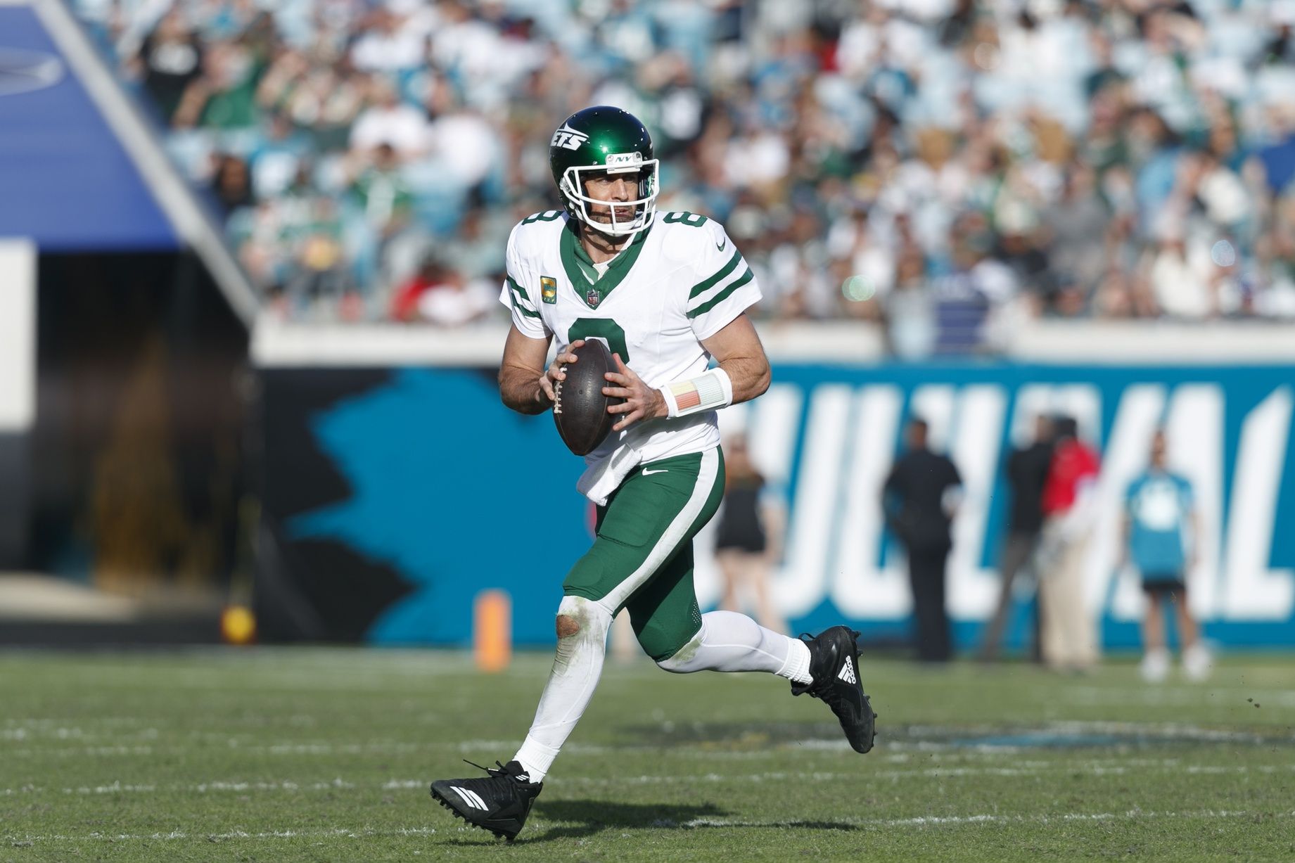 New York Jets quarterback Aaron Rodgers (8) looks for a pass against the Jacksonville Jaguars during the fourth quarter at EverBank Stadium.