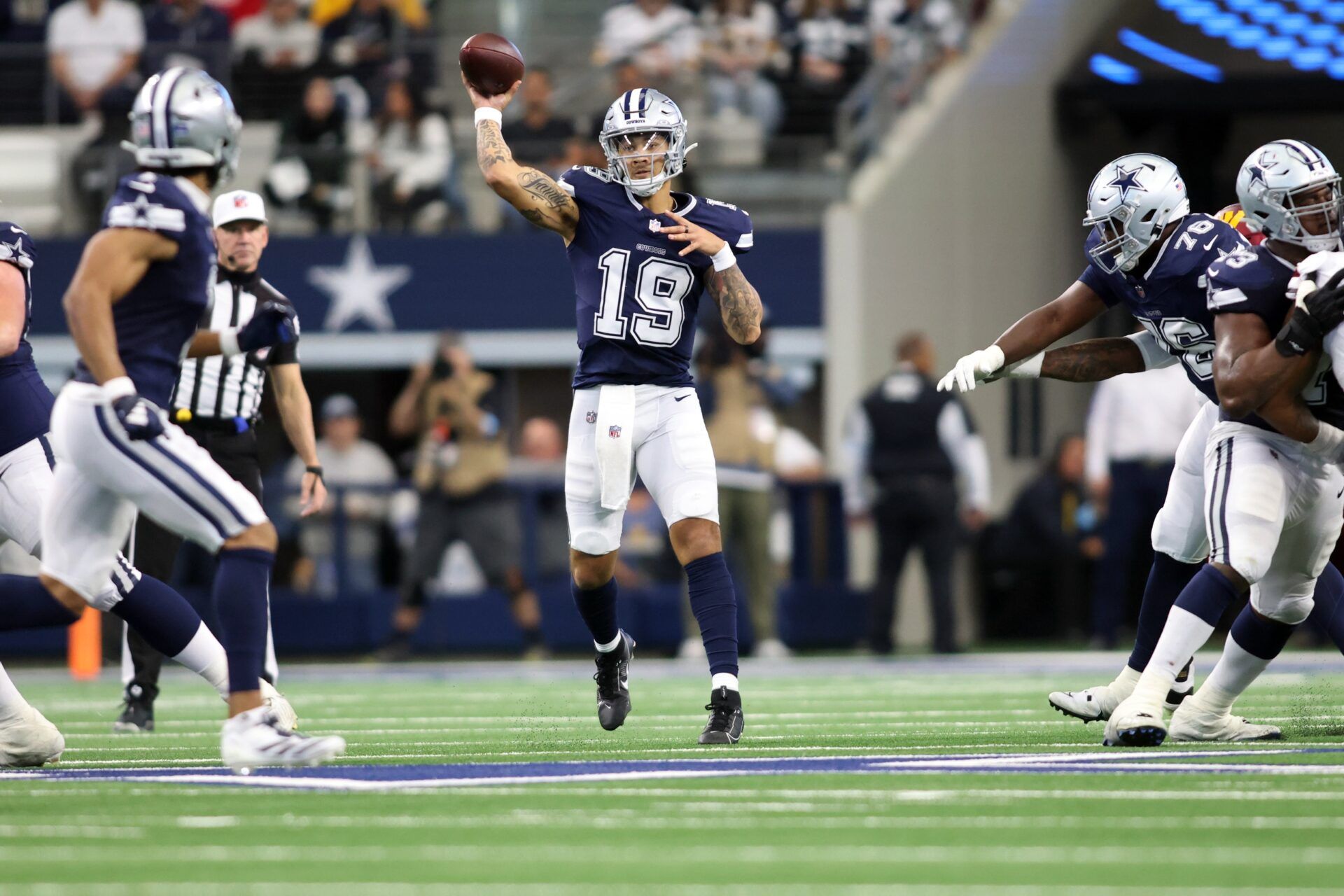 Dallas Cowboys quarterback Trey Lance (19) throws a pass against the Washington Commanders during the third quarter at AT&T Stadium.