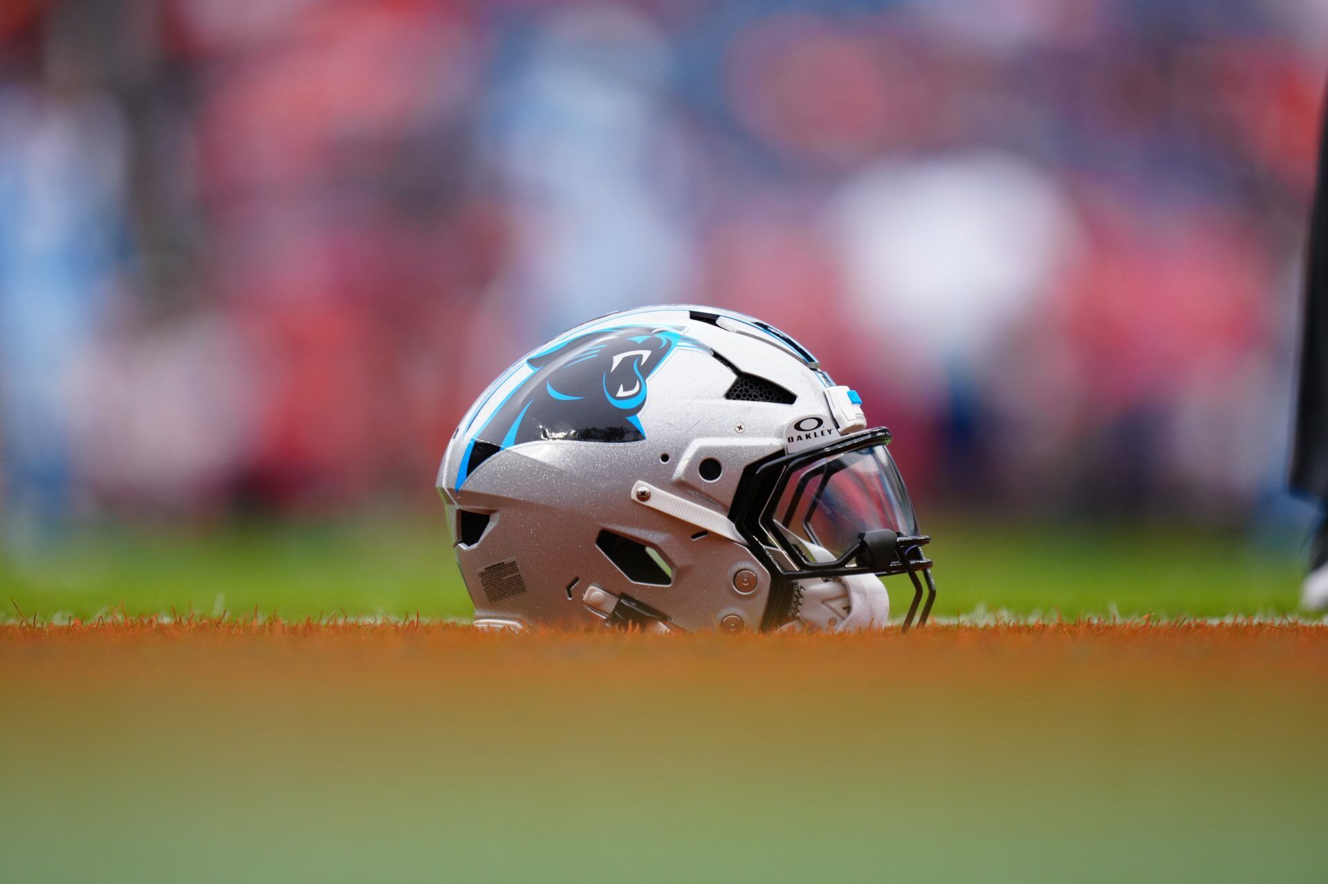 Detailed view of a Carolina Panthers helmet on the turf at Empower Field before the game against the Denver Broncos at Mile High.