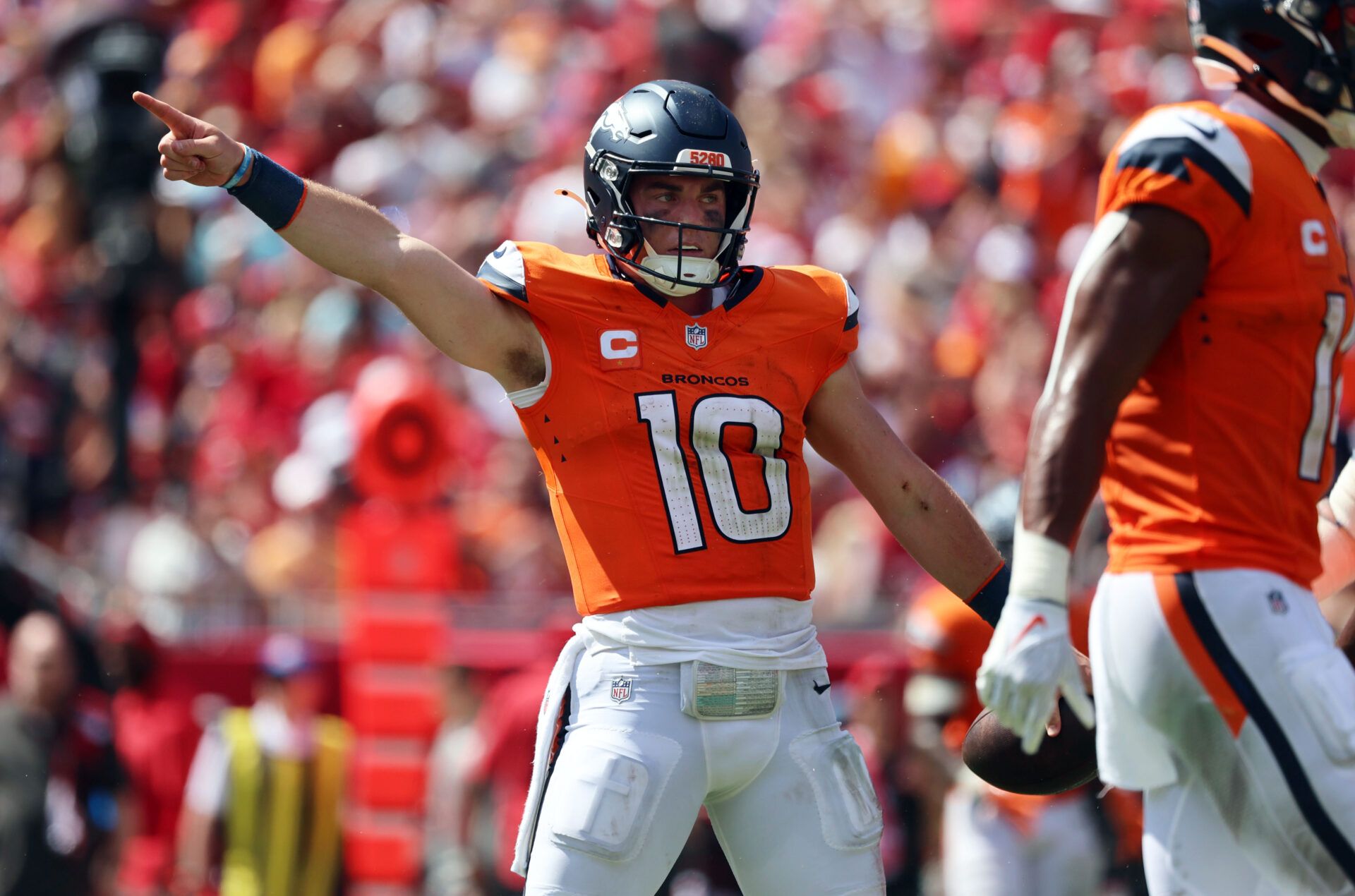 Sep 22, 2024; Tampa, Florida, USA; Denver Broncos quarterback Bo Nix (10) reacts after he gets first down against the Tampa Bay Buccaneers during the second half at Raymond James Stadium. Mandatory Credit: Kim Klement Neitzel-Imagn Images