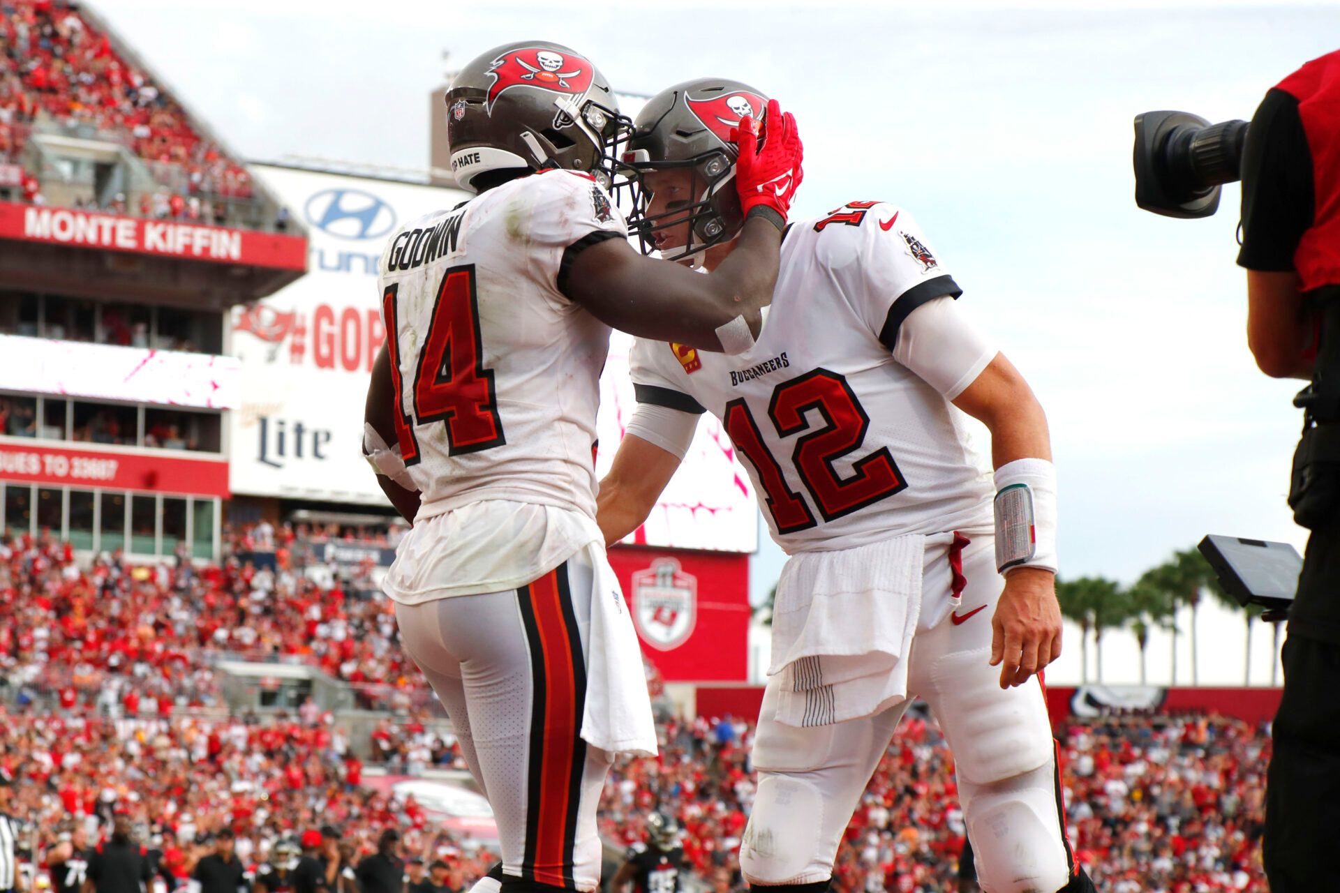 Tom Brady's legacy continues to shape the Buccaneers, influencing team culture and player retention, as seen in Chris Godwin's decision.