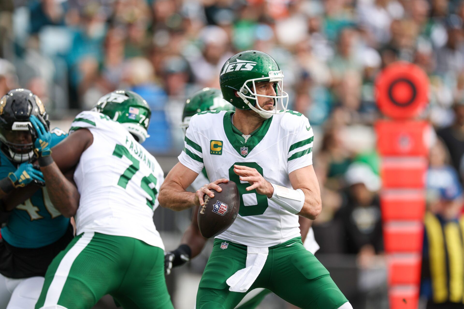 New York Jets quarterback Aaron Rodgers (8) drops back to pass against the Jacksonville Jaguars in the first quarter at EverBank Stadium.