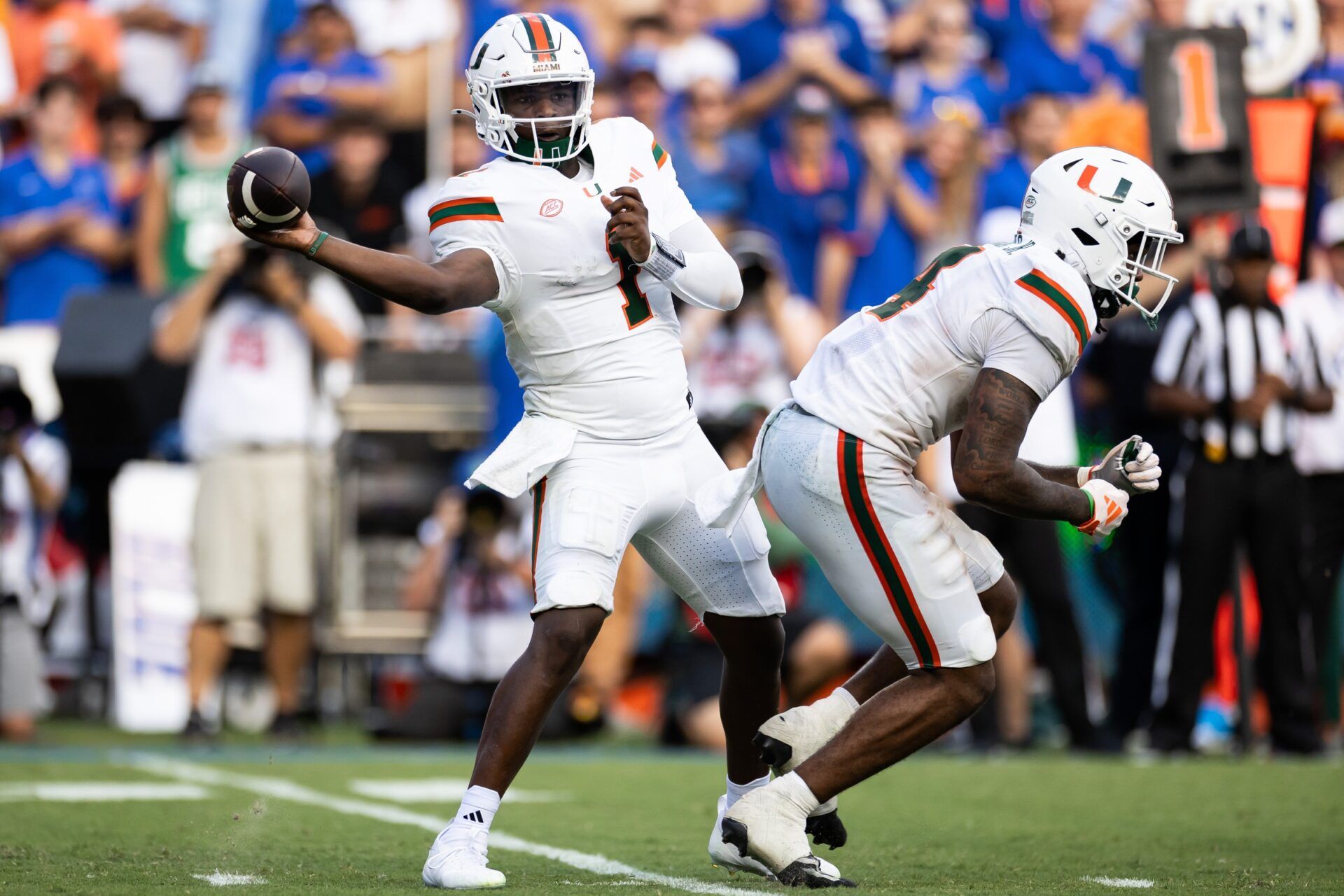 Miami Hurricanes quarterback Cam Ward (1) throws the ball against the Florida Gators during the second half at Ben Hill Griffin Stadium.