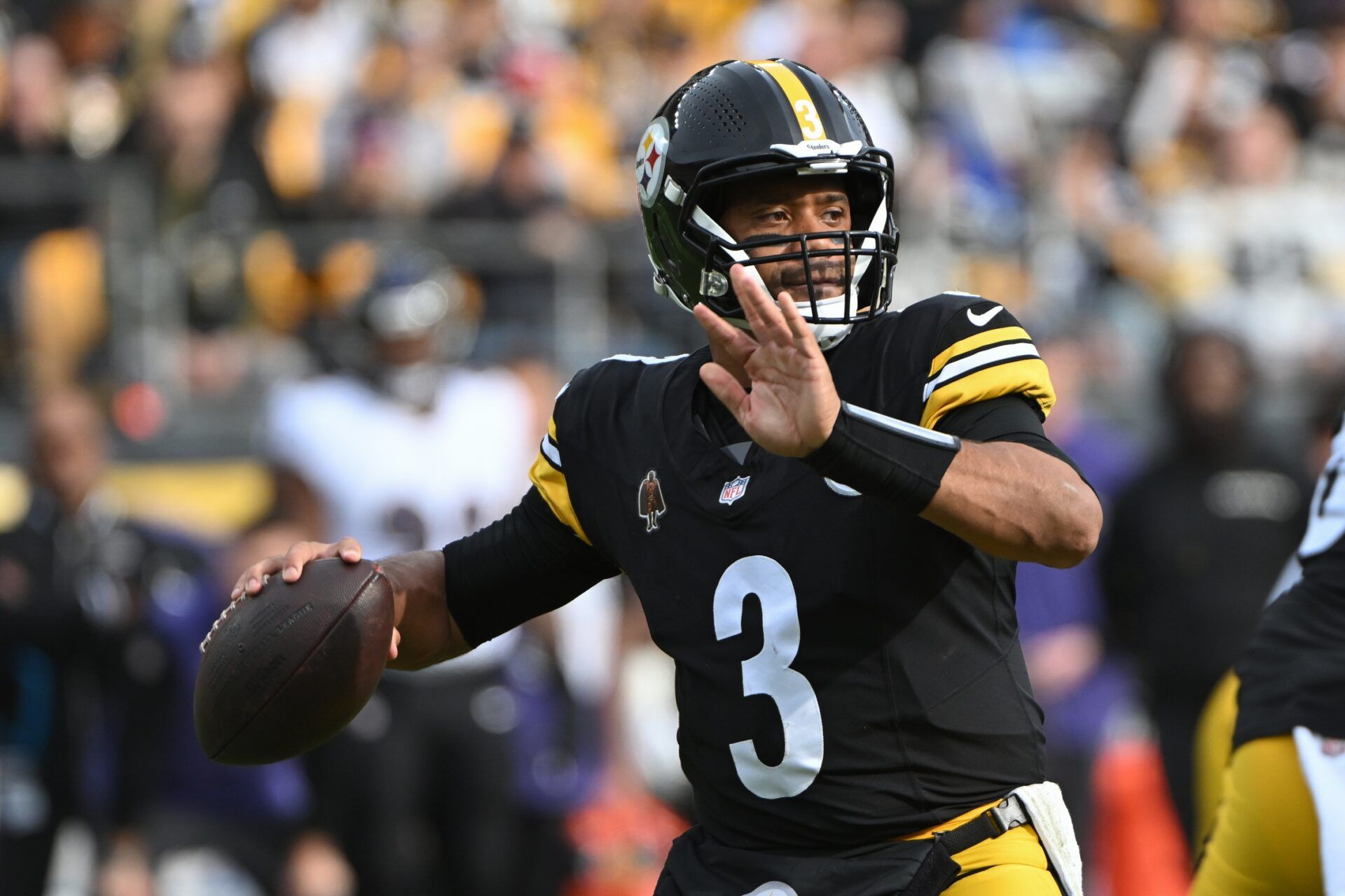 Pittsburgh Steelers quarterback Russell Wilson (3) throws a pass against the Baltimore Ravens during the first quarter at Acrisure Stadium.