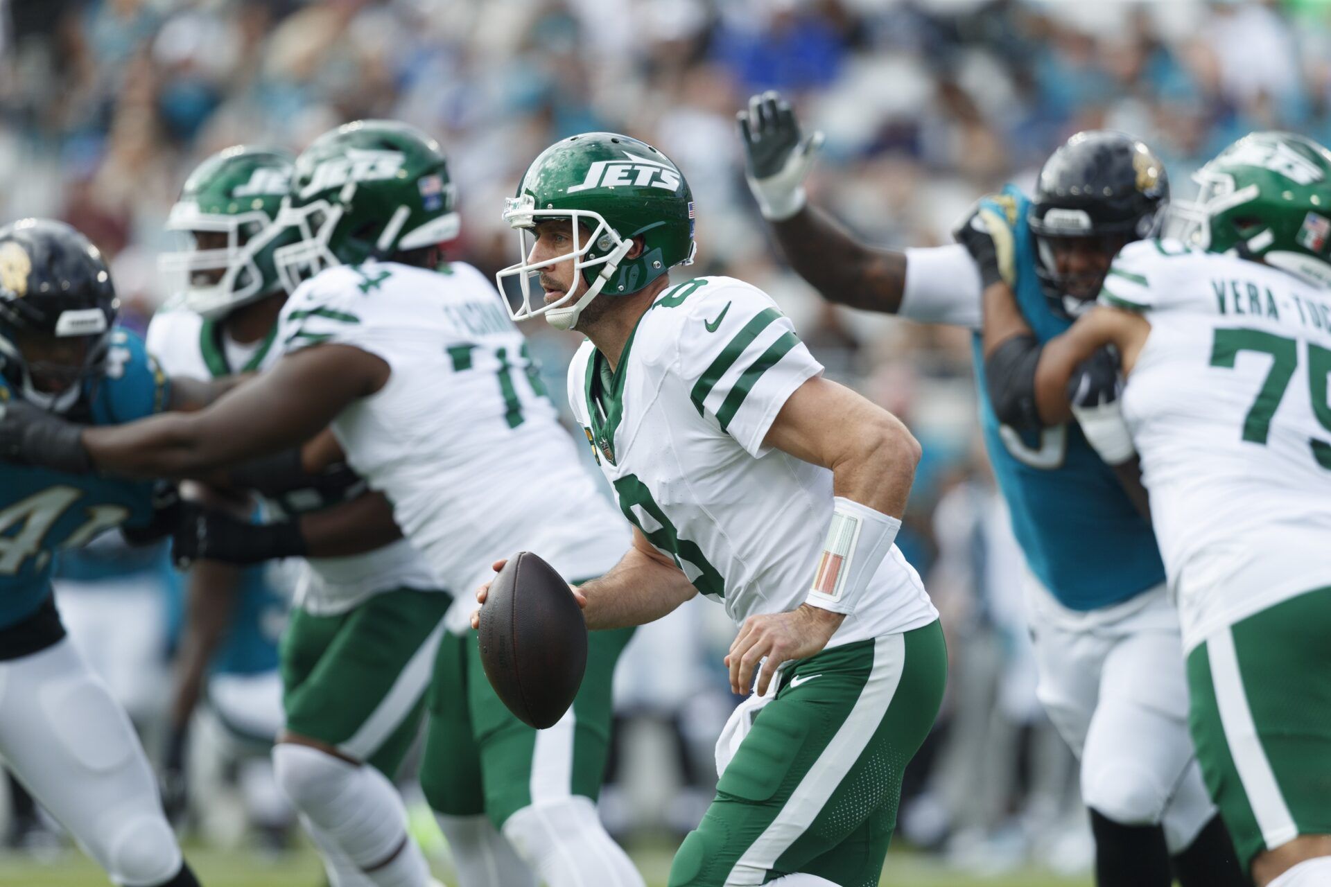 New York Jets quarterback Aaron Rodgers (8) runs the ball against the Jacksonville Jaguars during the first quarter at EverBank Stadium.