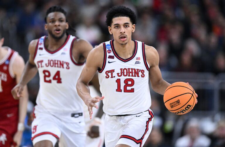 St. John's Red Storm guard RJ Luis Jr. (12) dribbles during the second half of a second round men’s NCAA Tournament game against the Arkansas Razorbacks at Amica Mutual Pavilion.